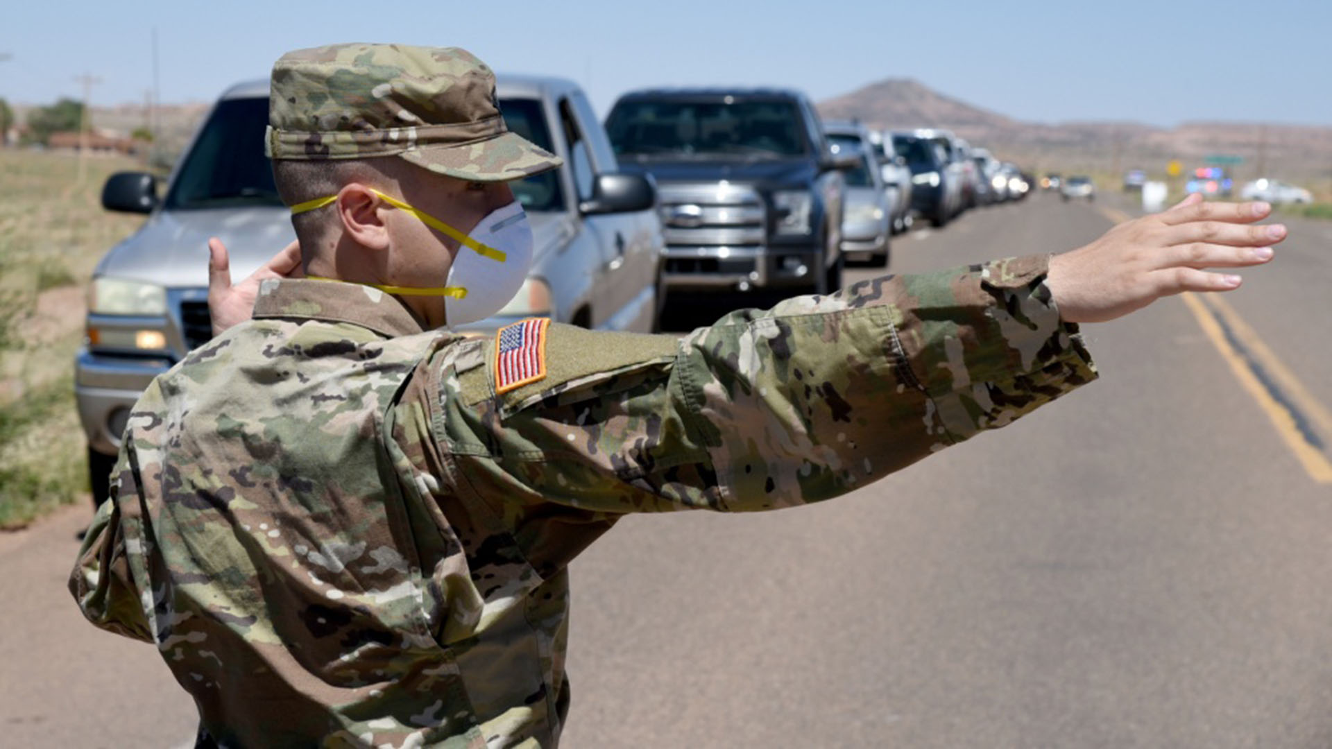 Arizona National Guard service member directs visitor traffic at COVID-19 testing site in Tonalea, Arizona, in the Navajo Nation May 19, 2020.