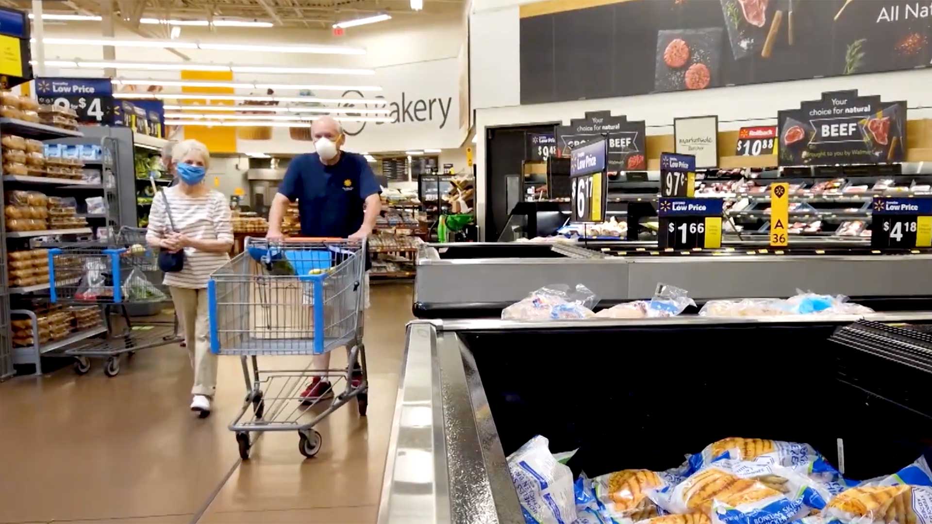 Two shoppers wear masks in a Tucson grocery store.