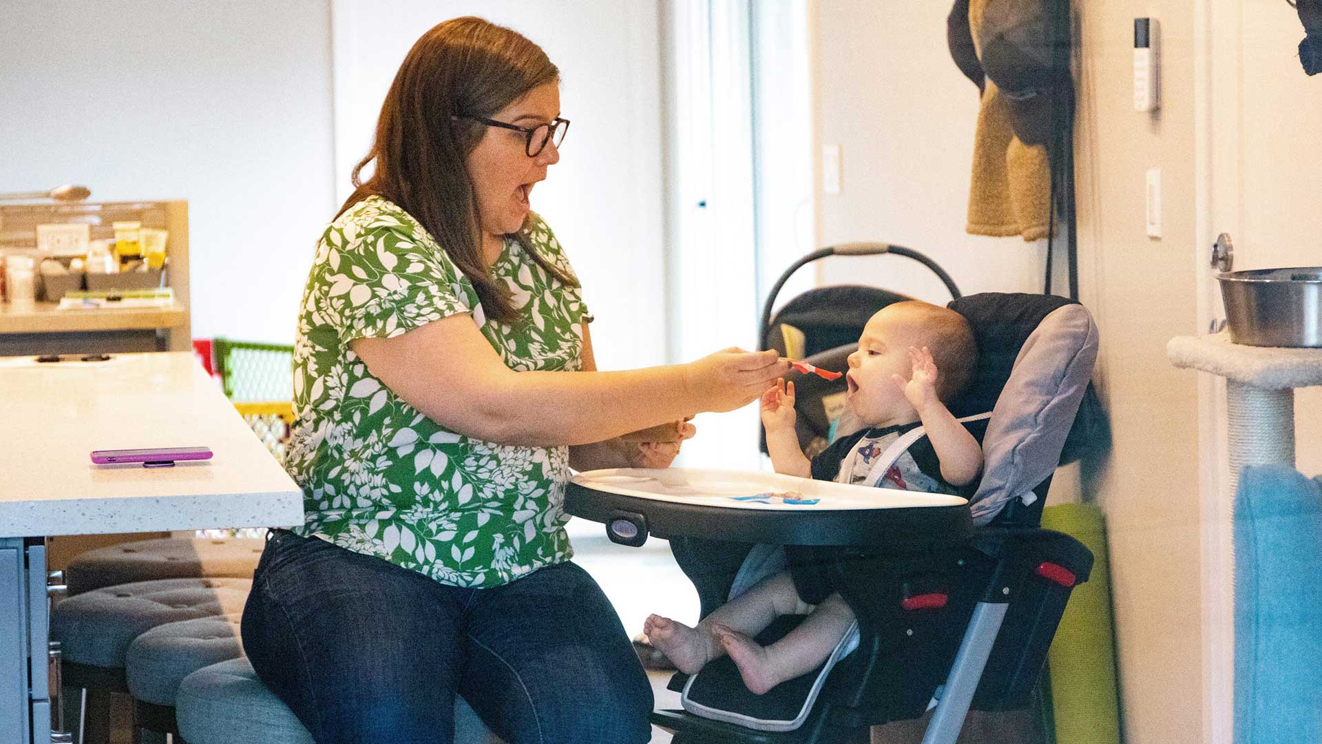 In this photo shot through a window of her home, Katie Gipson-McLean feeds 8-month-old Jay. She had a difficult time finding a place that would test her son for COVID-19 and, even then, she says, the practitioner was nervous about swabbing an infant so young.