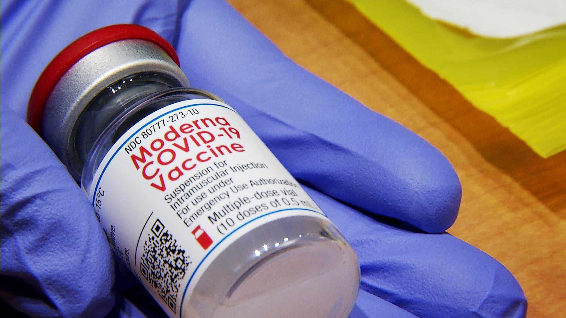 A health care worker holds a vial of Moderna's COVID-19 vaccine at a distribution event at Tucson Medical Center on Jan. 15, 2021. 