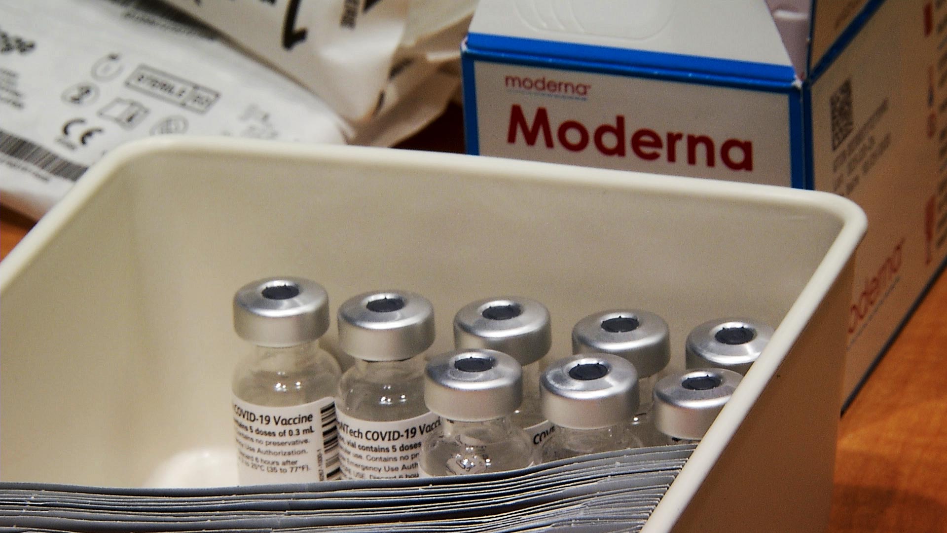 A container holds several vials of Moderna's COVID-19 vaccine at a distribution event at Tucson Medical Center on Jan. 15, 2021. 