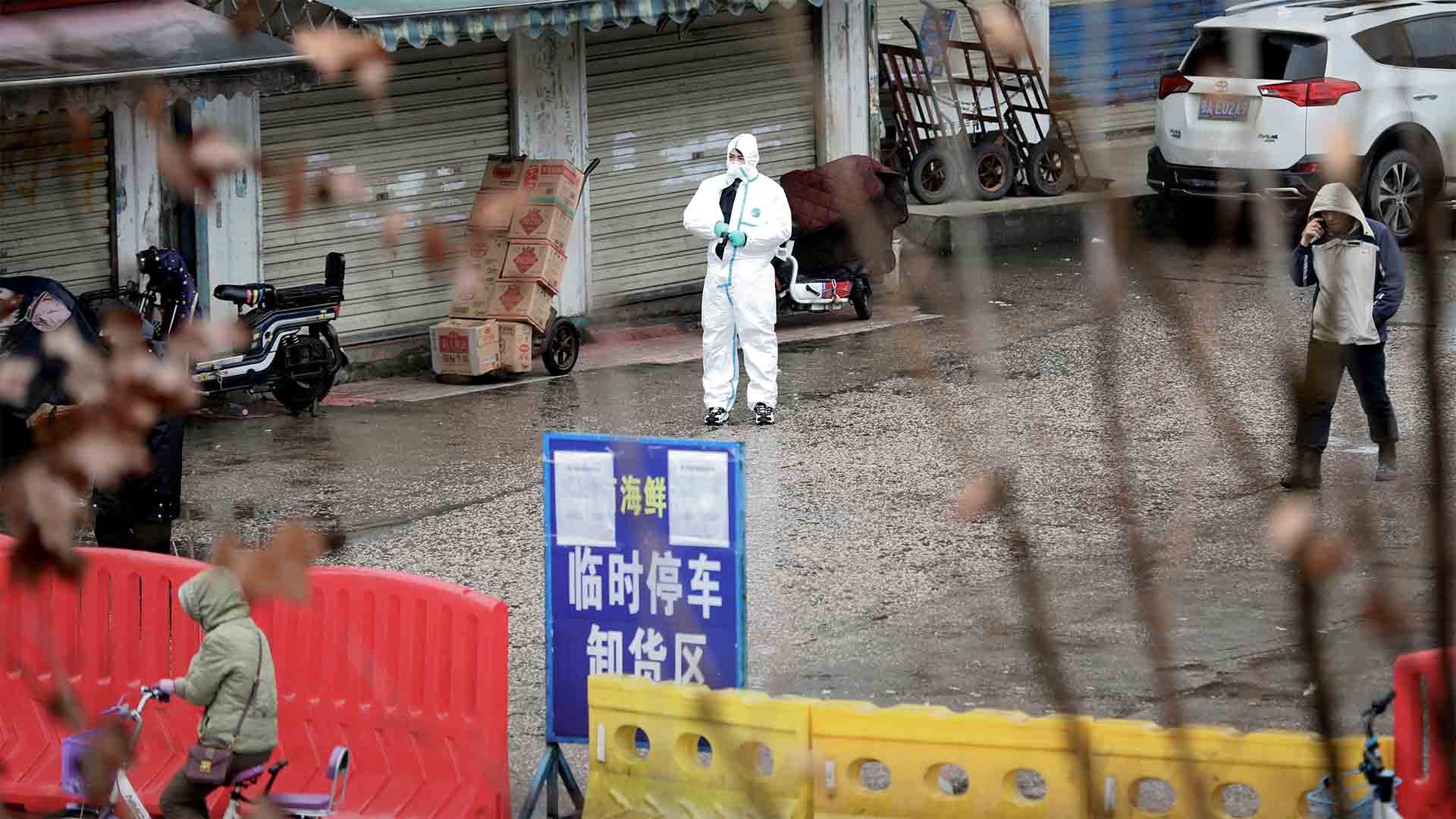 In January 2020, a worker in a protective suit is seen at the Huanan Seafood Market, thought to have been the initial epicenter of the COVID-19 outbreak in Wuhan, China.