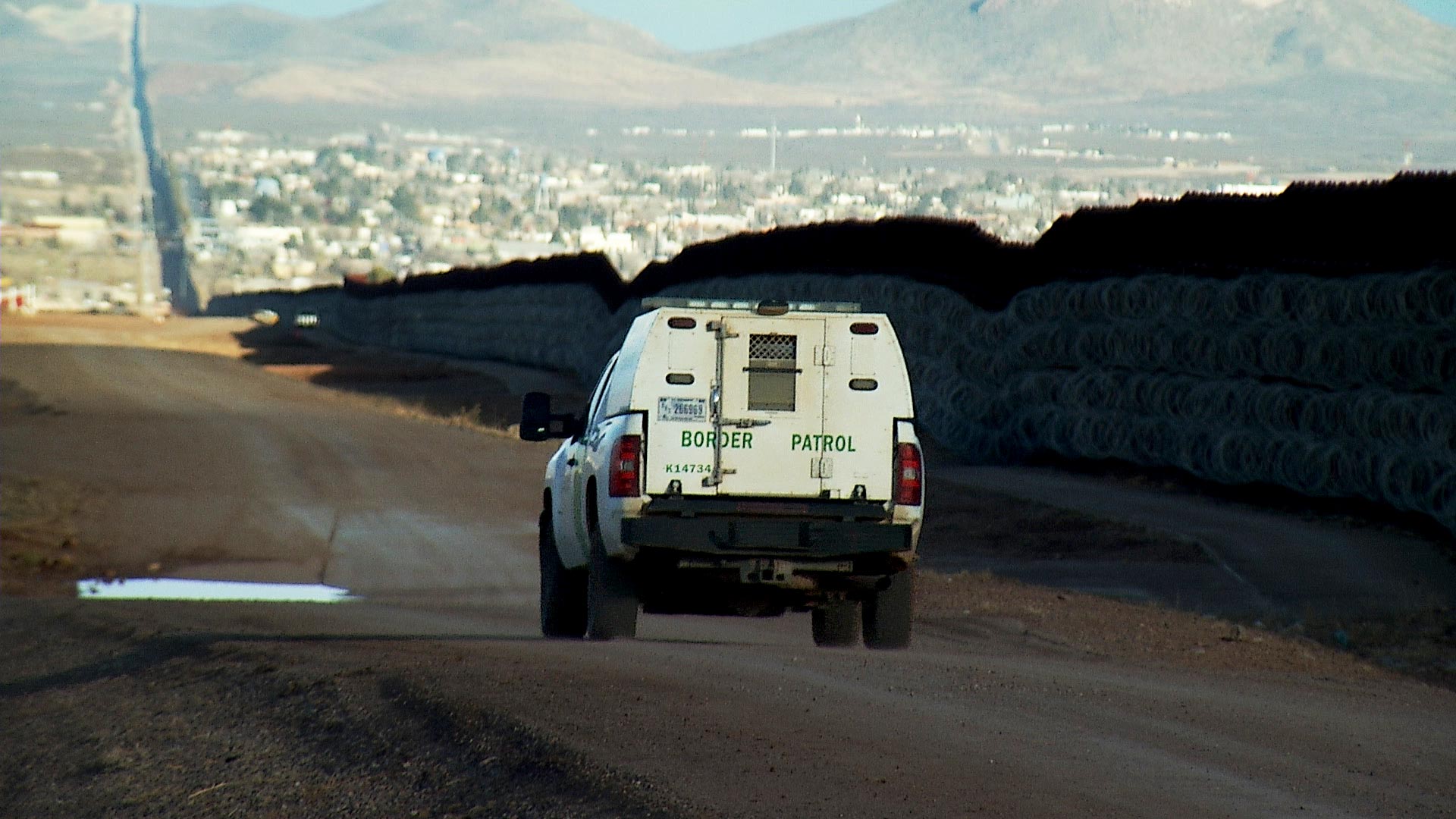 A border patrol vehicle drives along the border wall in Douglas, Ariz. January 2021.