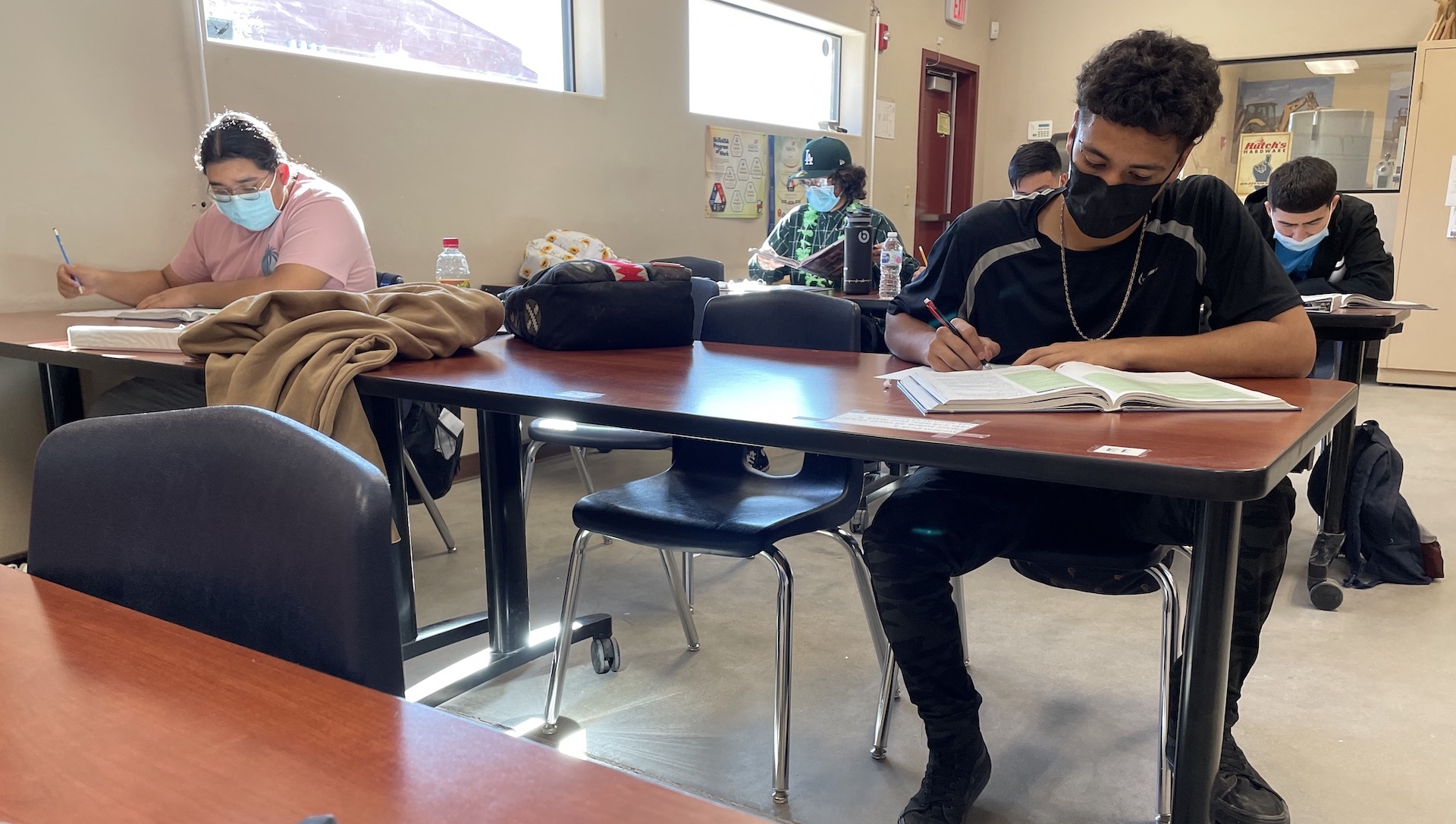 Jorge Rios is a student in Craig Bal’s class. He studies a construction textbook at the training center next to his high school on October 26th, 2021. 