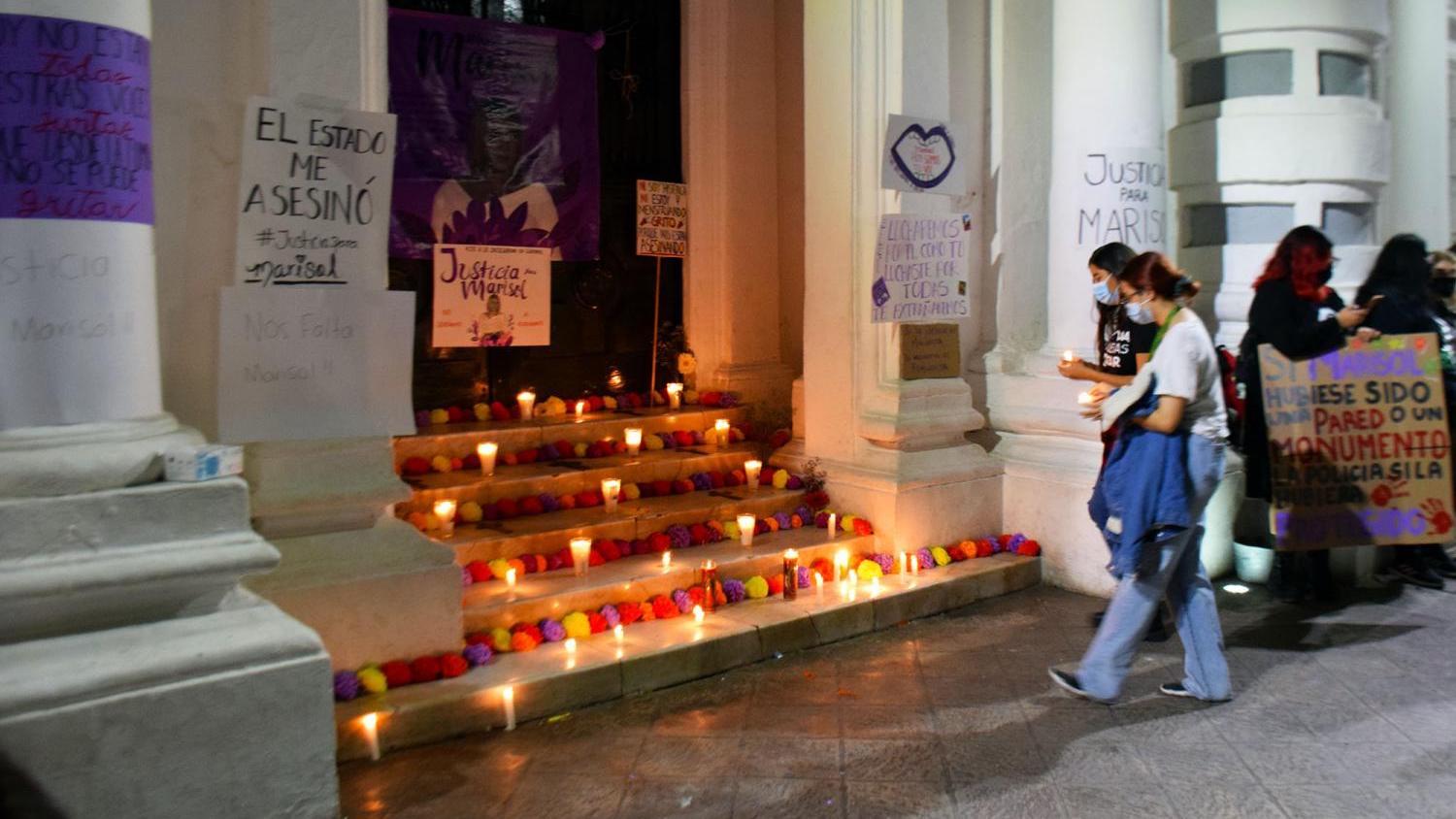 Women set candles under a poster calling for “Justice for Marisol” during a vigil on Sunday, Nov. 28, 2021 in Hermosillo, Sonora, for Marisol Cuadras, who was killed last week in Guaymas.