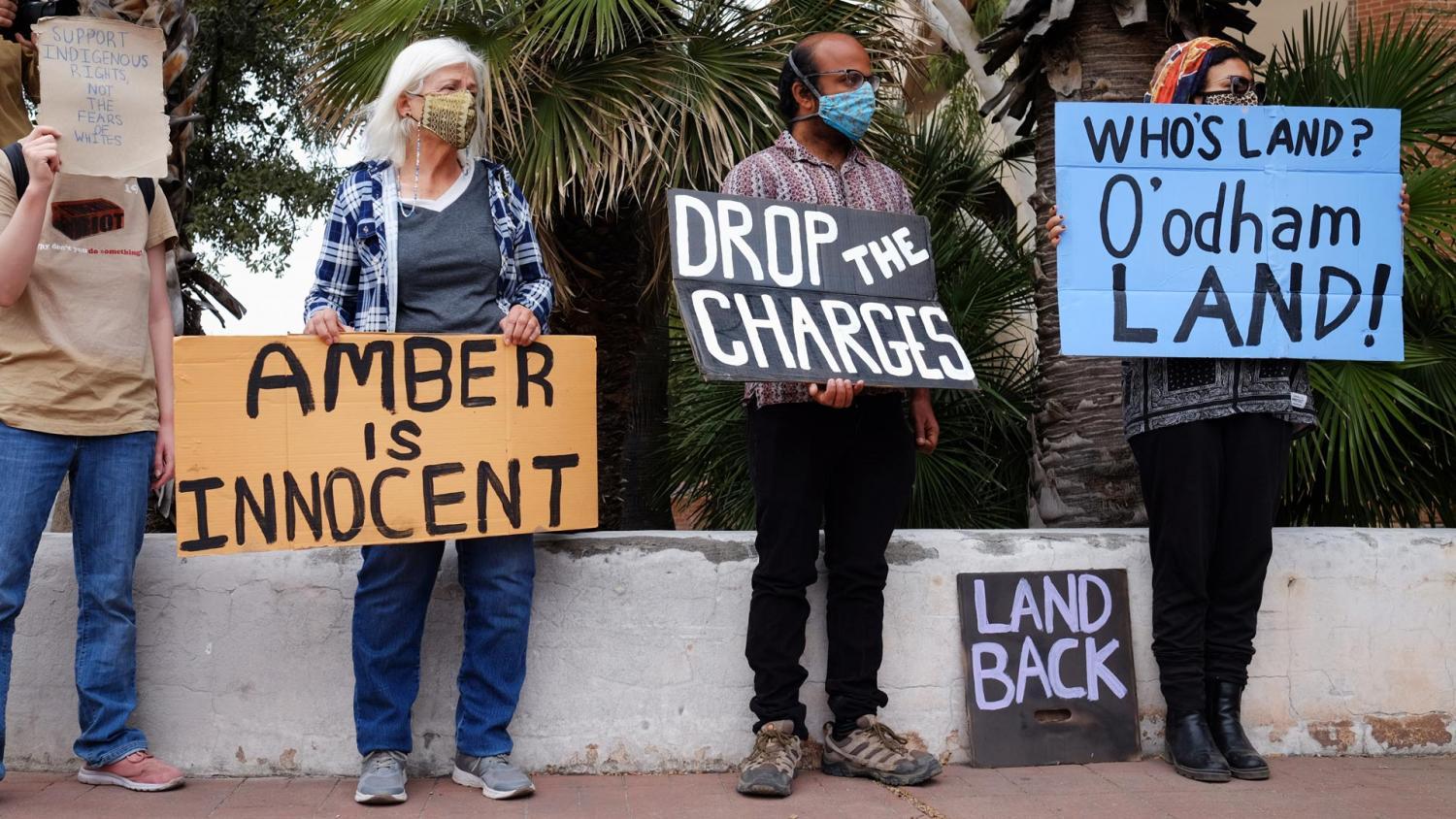 Supporters of Amber Ortega hold signs of support during a rally across the street from the federal courthouse in downtown Tucson on Nov. 23, 2021.