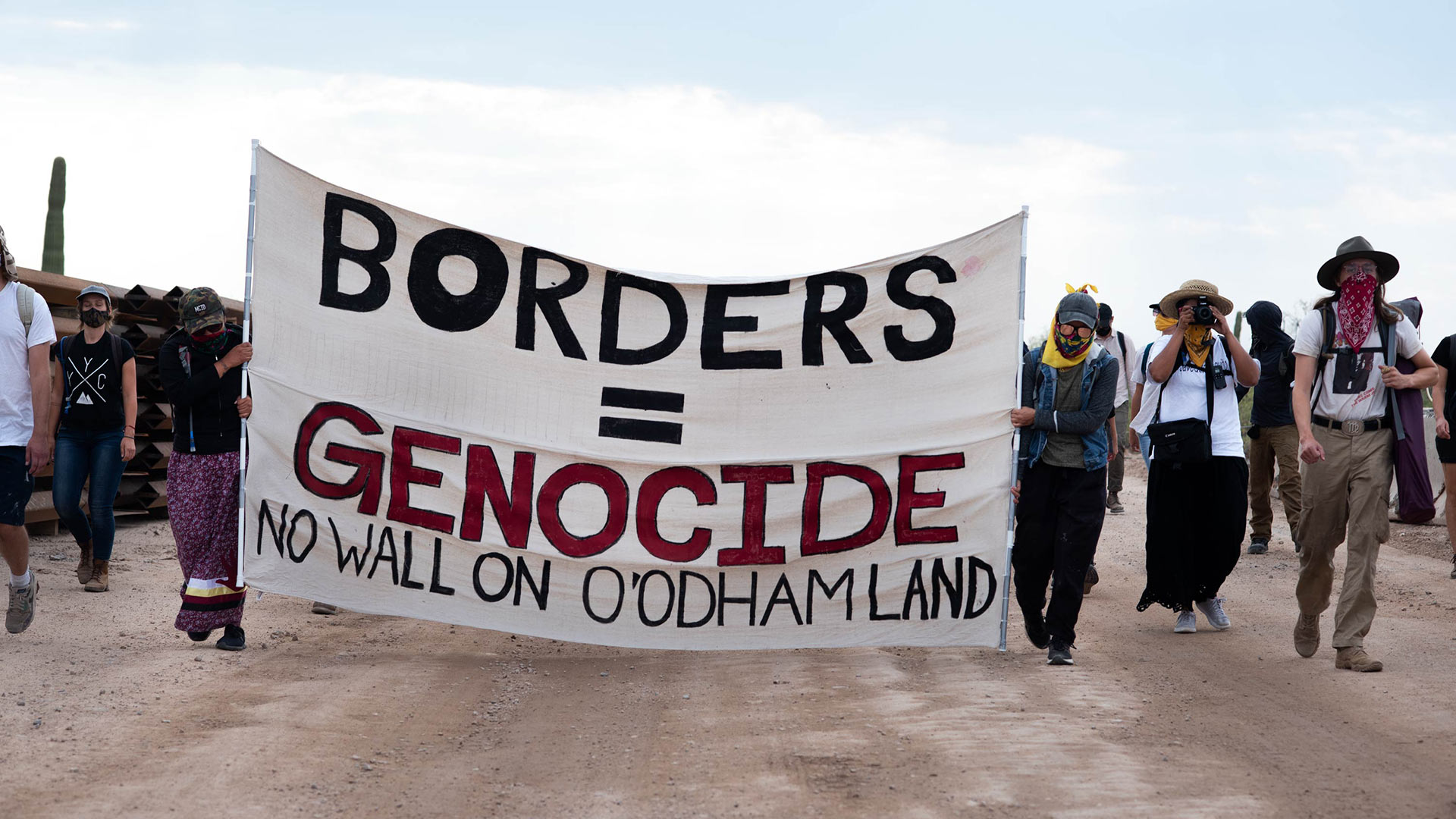 Indigenous-led protesters walk along a construction line in Organ Pipe Cactus National Monument in Sept. 2020.