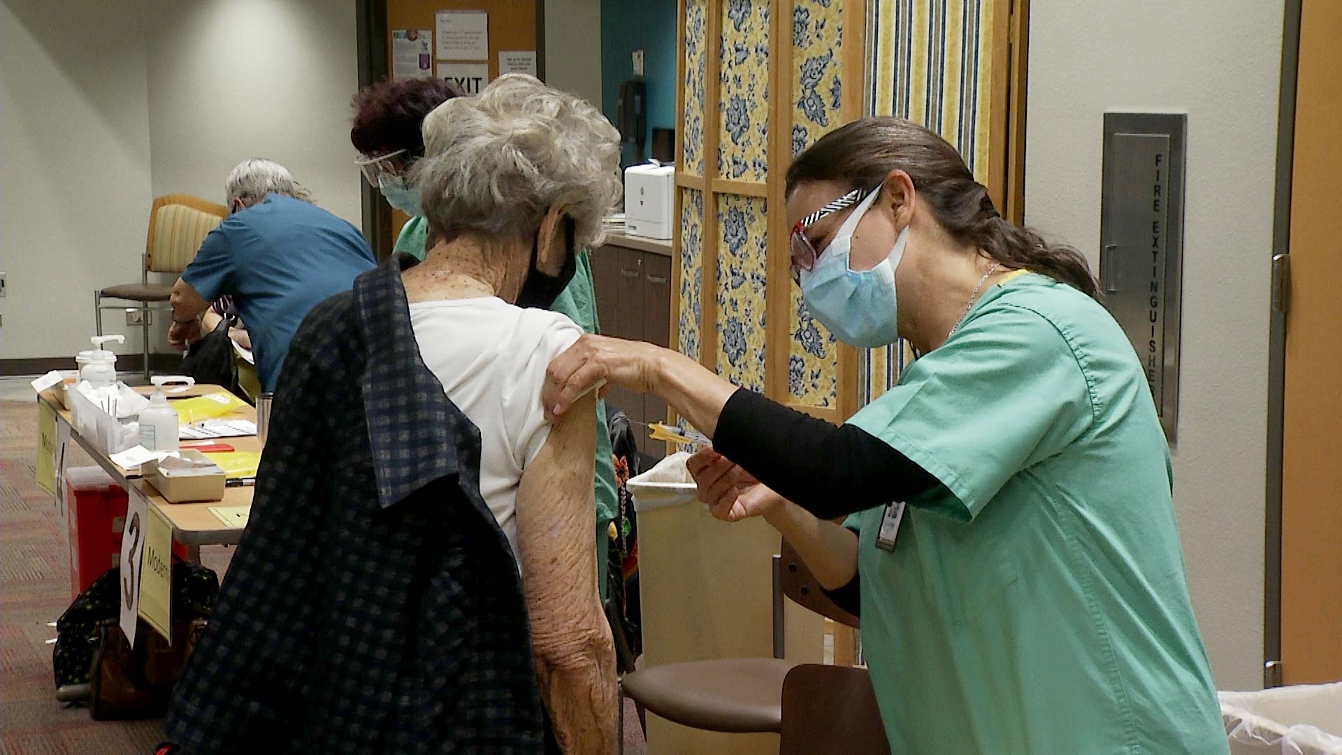 A woman receives a COVID-19 vaccine at Tucson Medical Center. January 2021. 