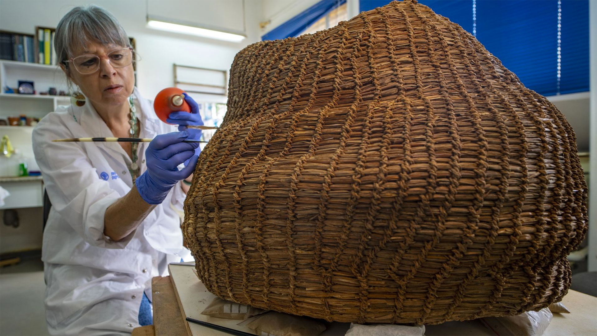 Conservation work on the basket in the Israel Antiquities Authority's laboratories.