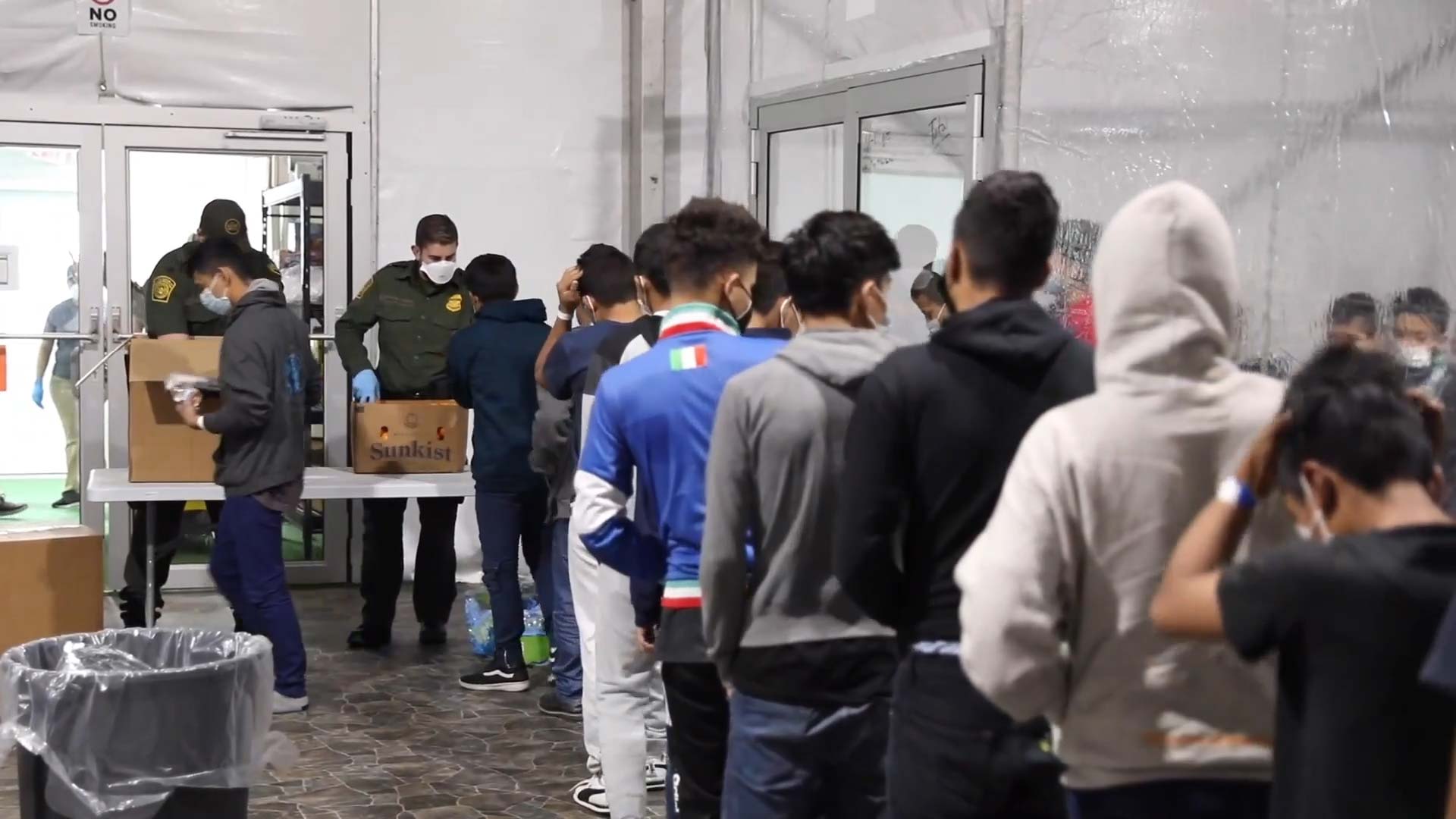 Unaccompanied minors apprehended by Customs and Border Protection line up inside a temporary processing facility in Donna, Texas on March 17, 2021. 