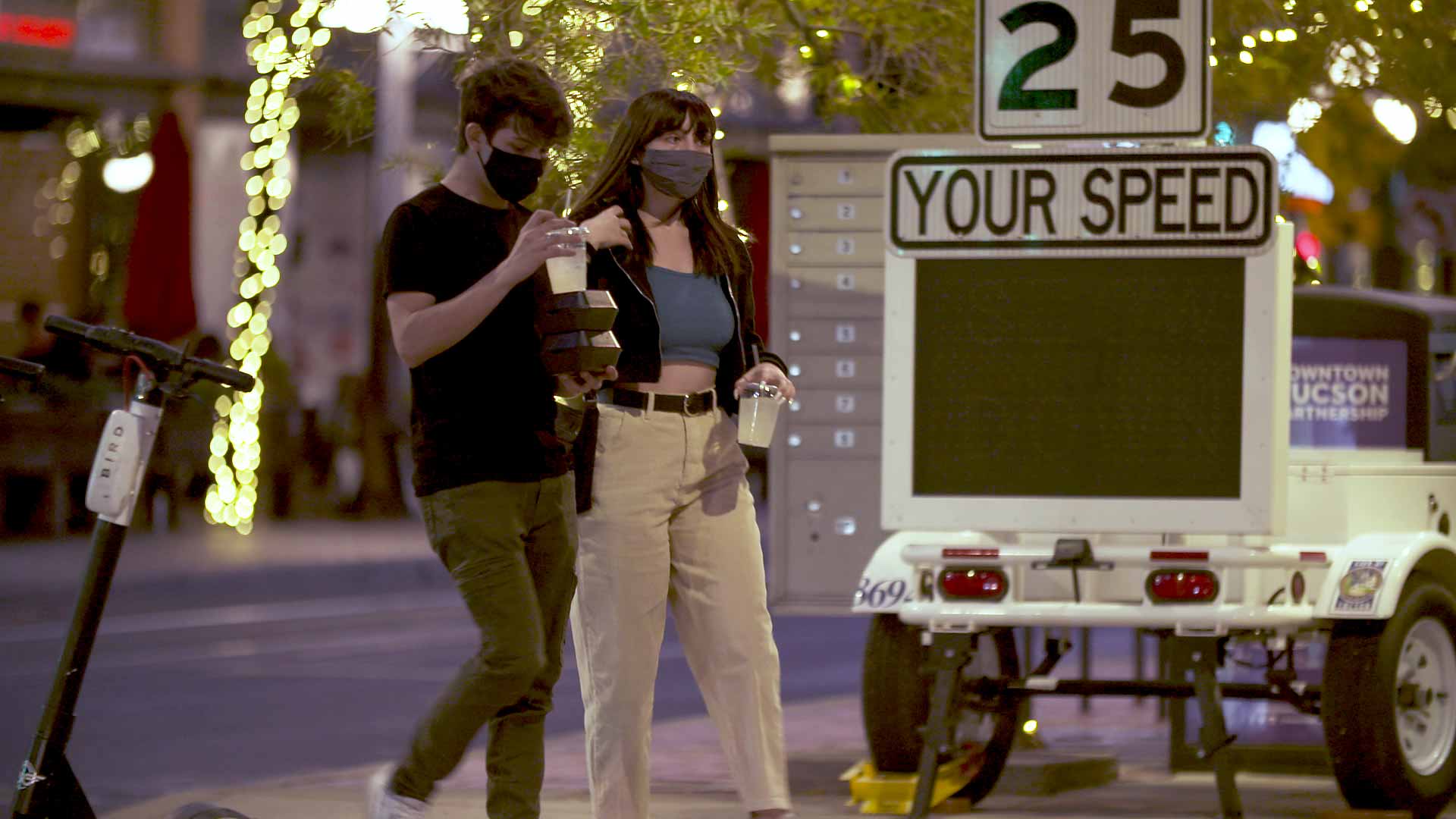 A man and woman wear masks as they walk in downtown Tucson. November 2020. 