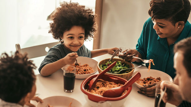 A family sits down to dinner.