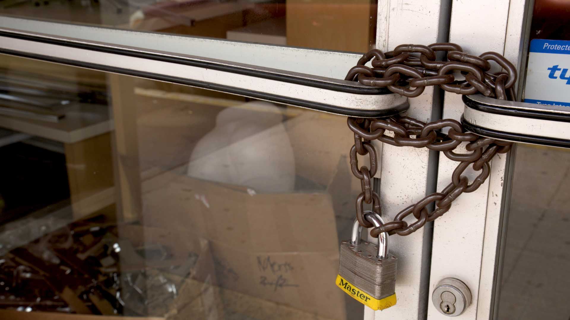 A lock and chain secures the doors of a closed business in Nogales. July 2021. 