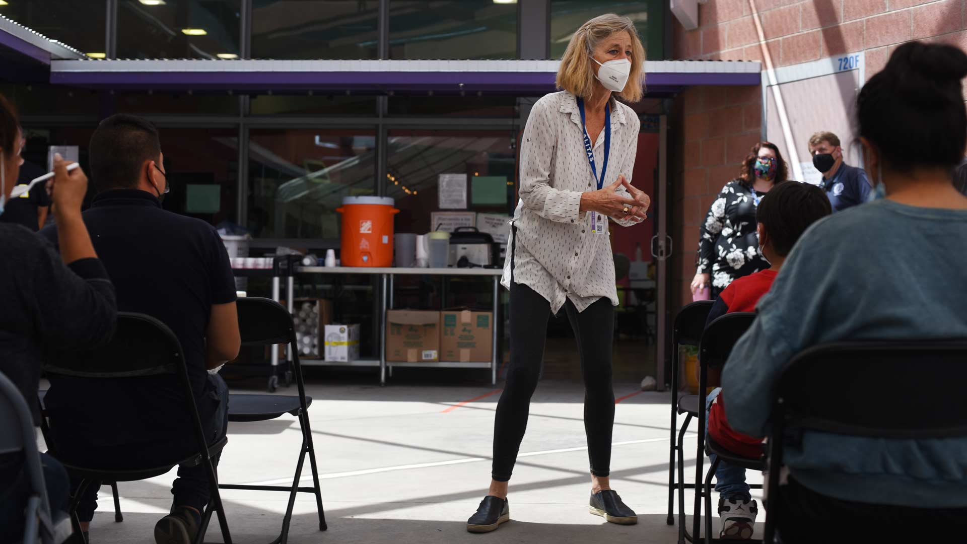 A staff member with the Casa Alitas Welcome Center gives an orientation to migrants who have just been brought from Nogales by the Border Patrol. Migrants will stay at the center for a few days while working out travel arrangements to connect with family in the U.S. 