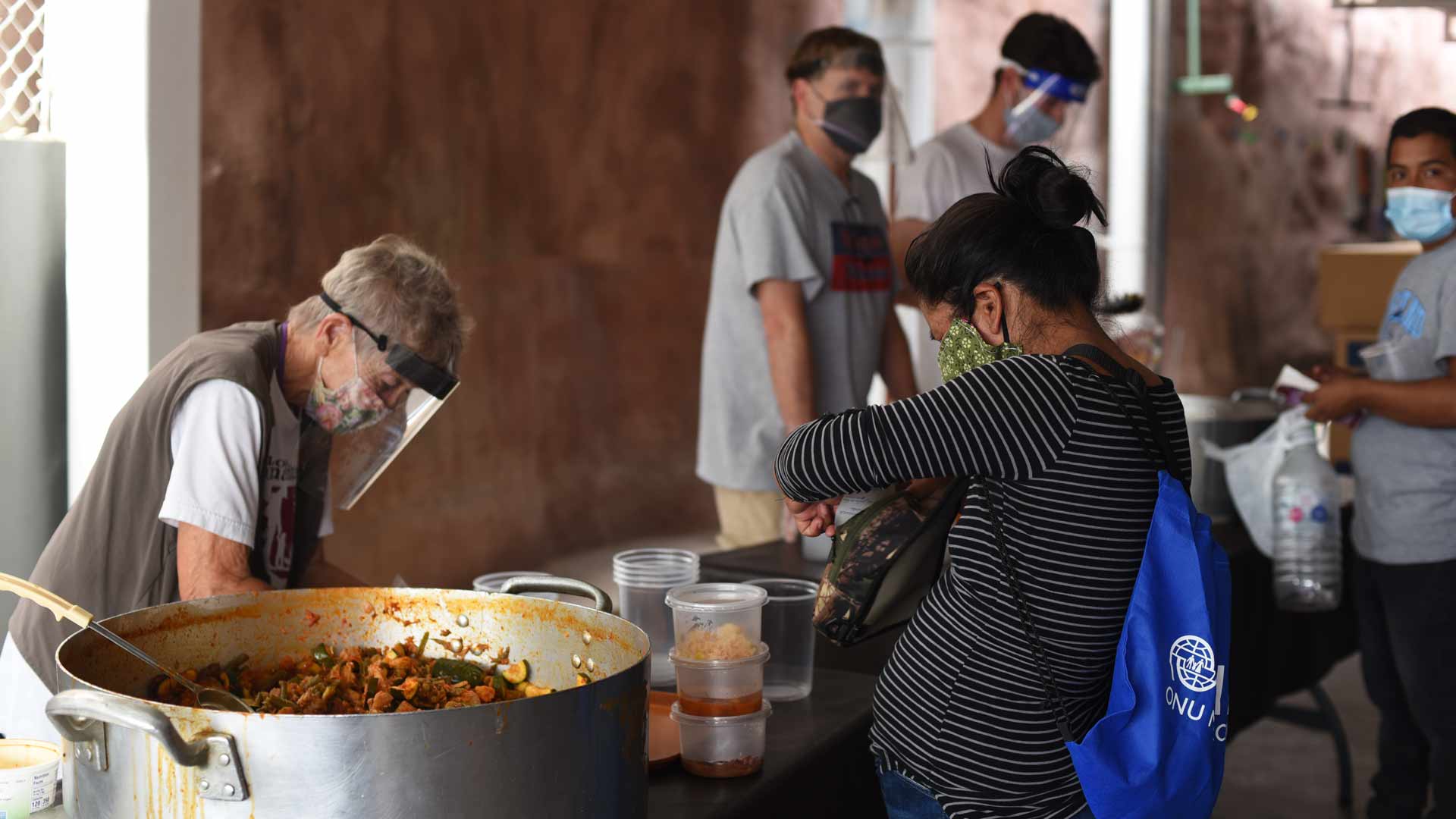 A migrant receives a serving of breakfast at the Kino Border Initiative in Nogales, Sonora. The faith-based shelter offers food, showers and other services, and also partners with legal aid groups to offer case assistance.