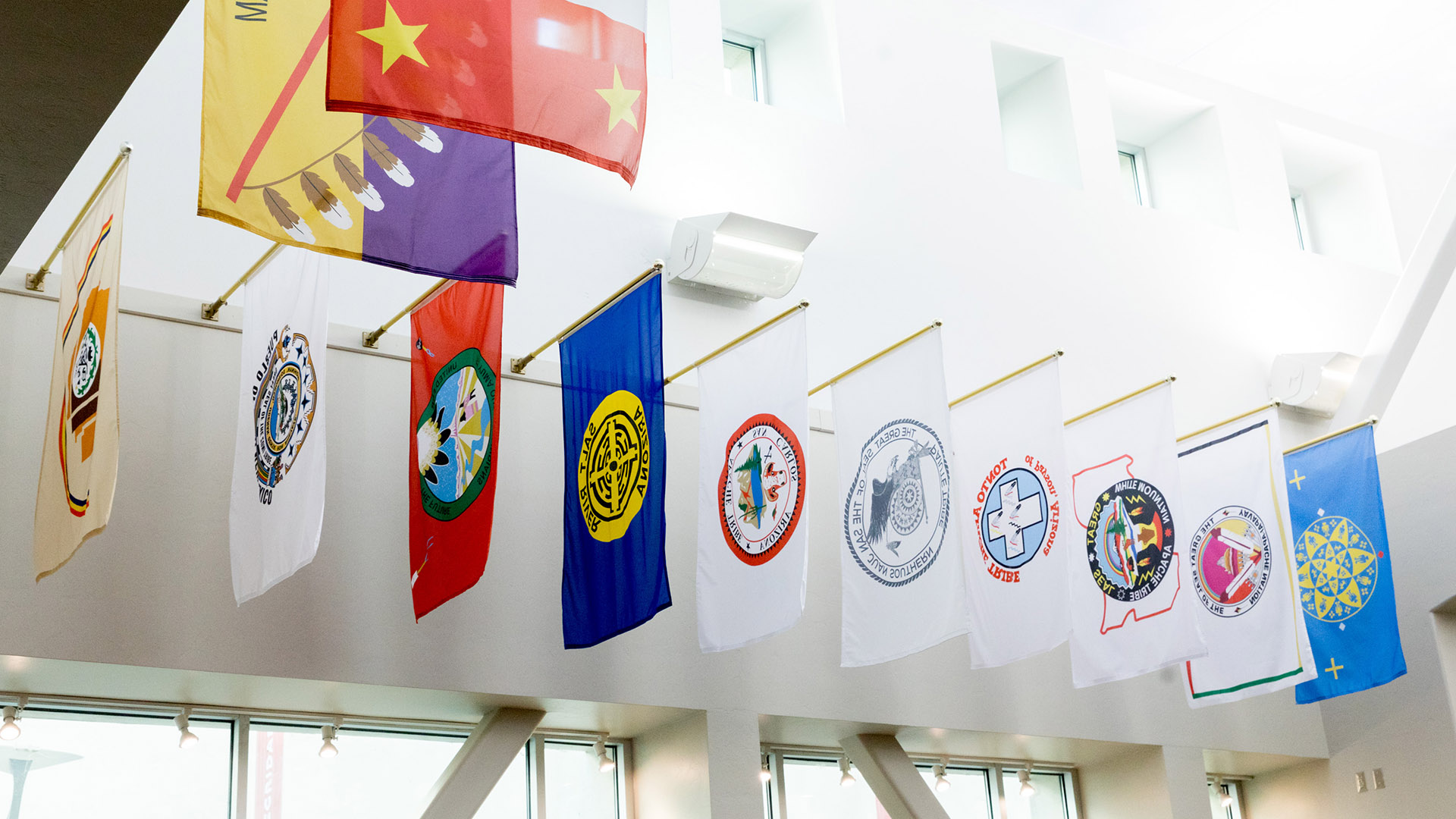 Flags from Arizona's 22 federally recognized tribes displayed at the University of Arizona bookstore in November 2020. 
