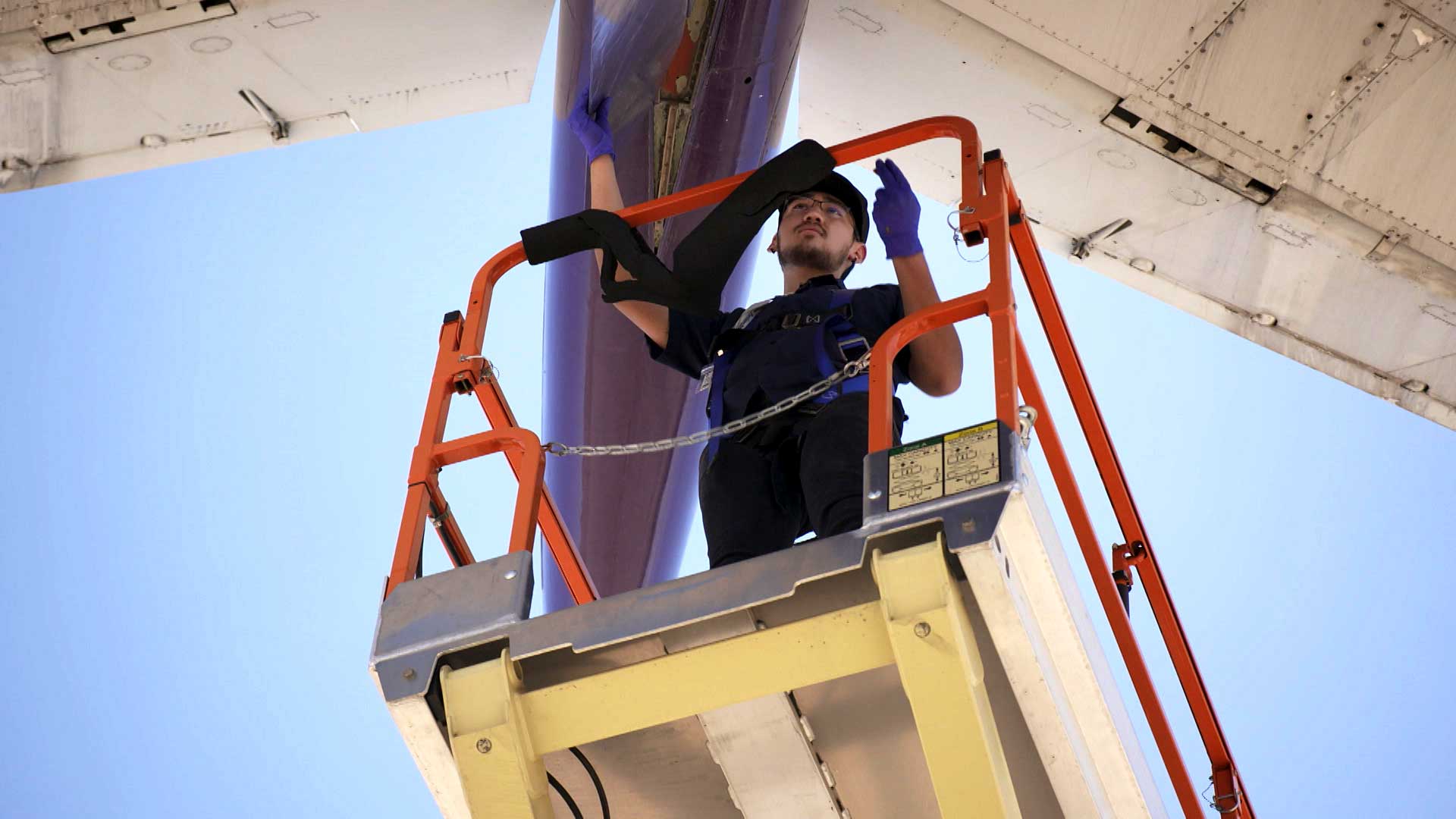 José Pérez, an aviation technology student at Pima Community College, works on a FedEx cargo airplane as part of his training at the college. June 2021. 