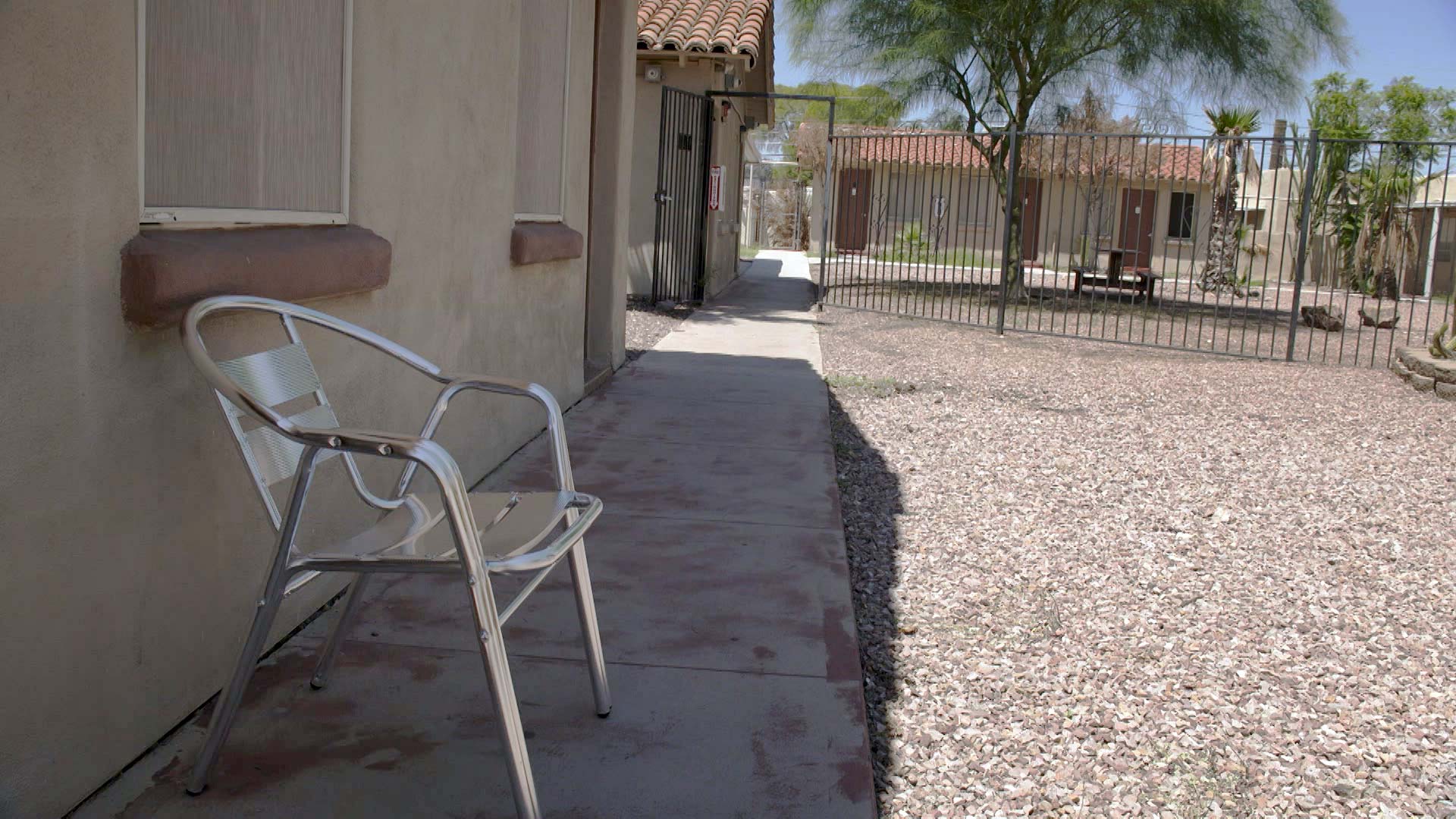 An empty chair outside of a former motel on North Oracle Road that the city of Tucson purchased and transformed into bridge housing for people experiencing homelessness. August 2021.