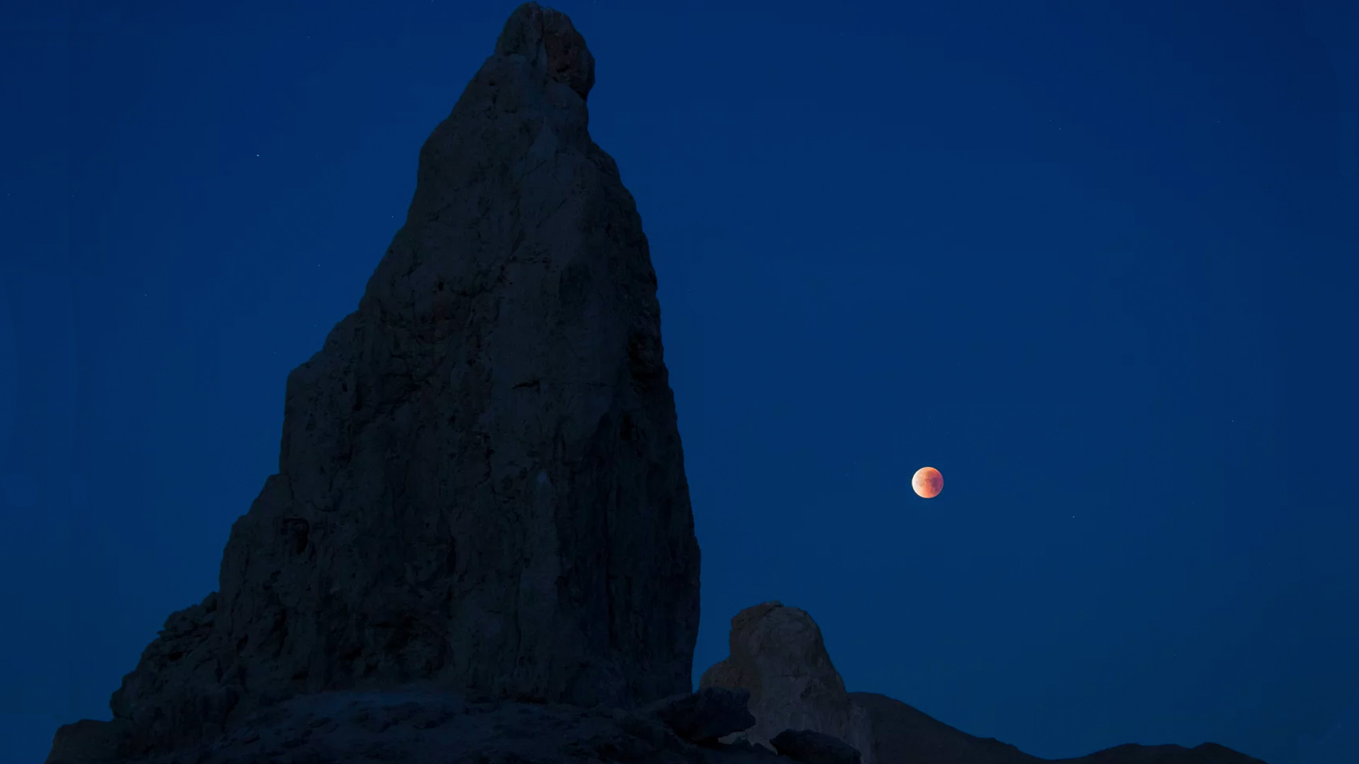 A lunar eclipse viewed from California's Trona Pinnacles Desert National Conservation Area. Scientists believe there may be more moons in the galaxy than planets.

