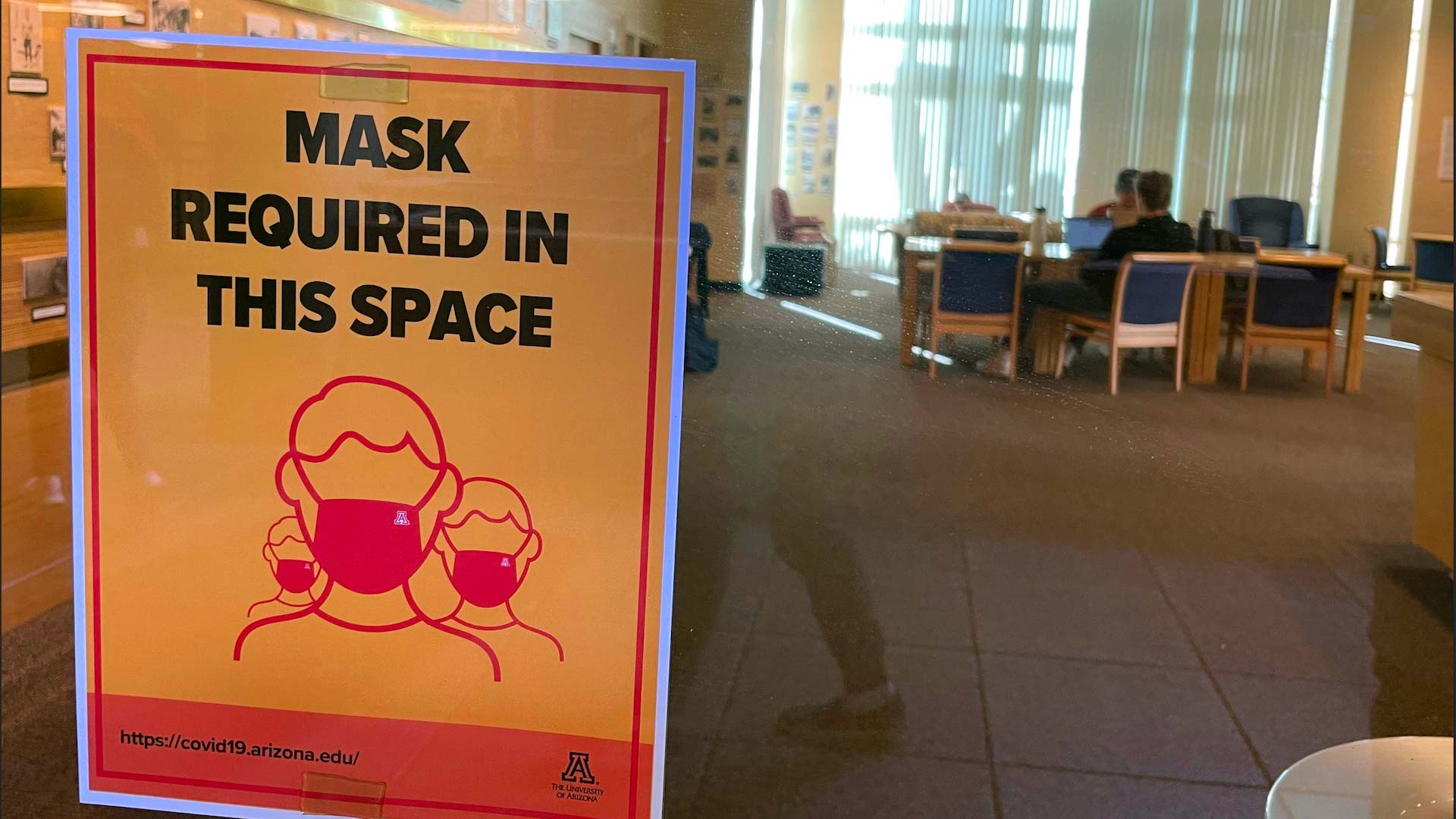 A sign requiring students to wear masks near the University of Arizona student union in Tucson on Jan. 20, 2021. 