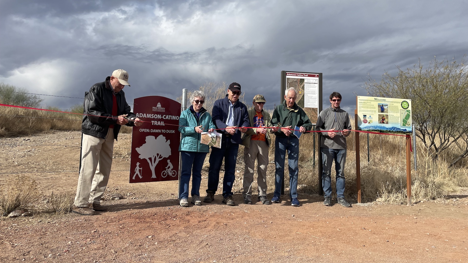Speakers cut the ribbon the Adamson-Catino Trail dedication ceremony in Green Valley's Canoa Preserve Park. 