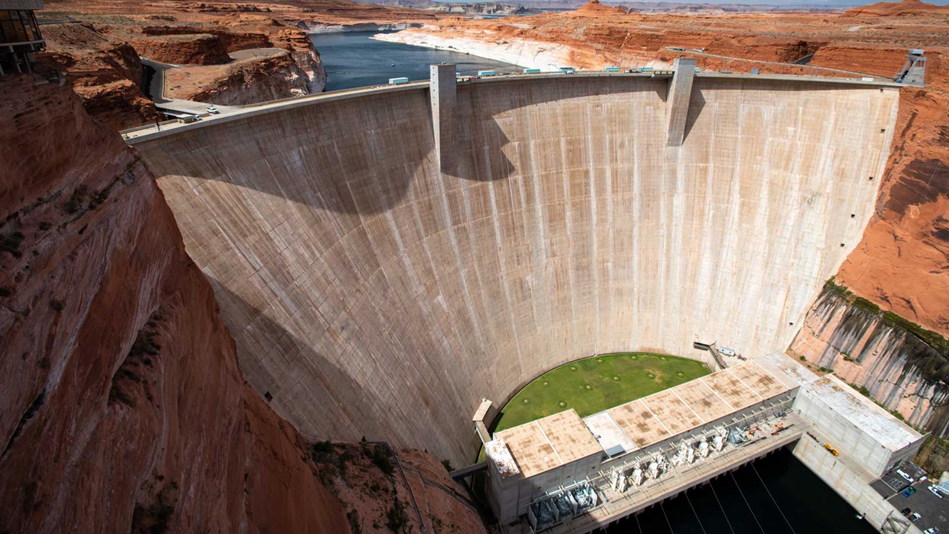 Water levels are at record lows and still dropping in the nation's largest reservoirs. The federal government began the process of restricting water releases from Glen Canyon Dam, which holds back a shrinking Lake Powell.
