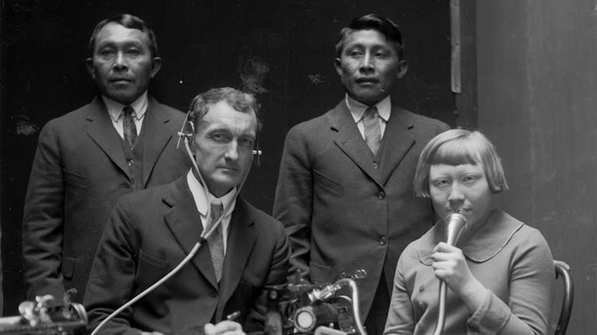 J.P. Harrington posing with three Cuna (Tule) people while making Dictaphone recordings of Cuna language and songs, 1924. 