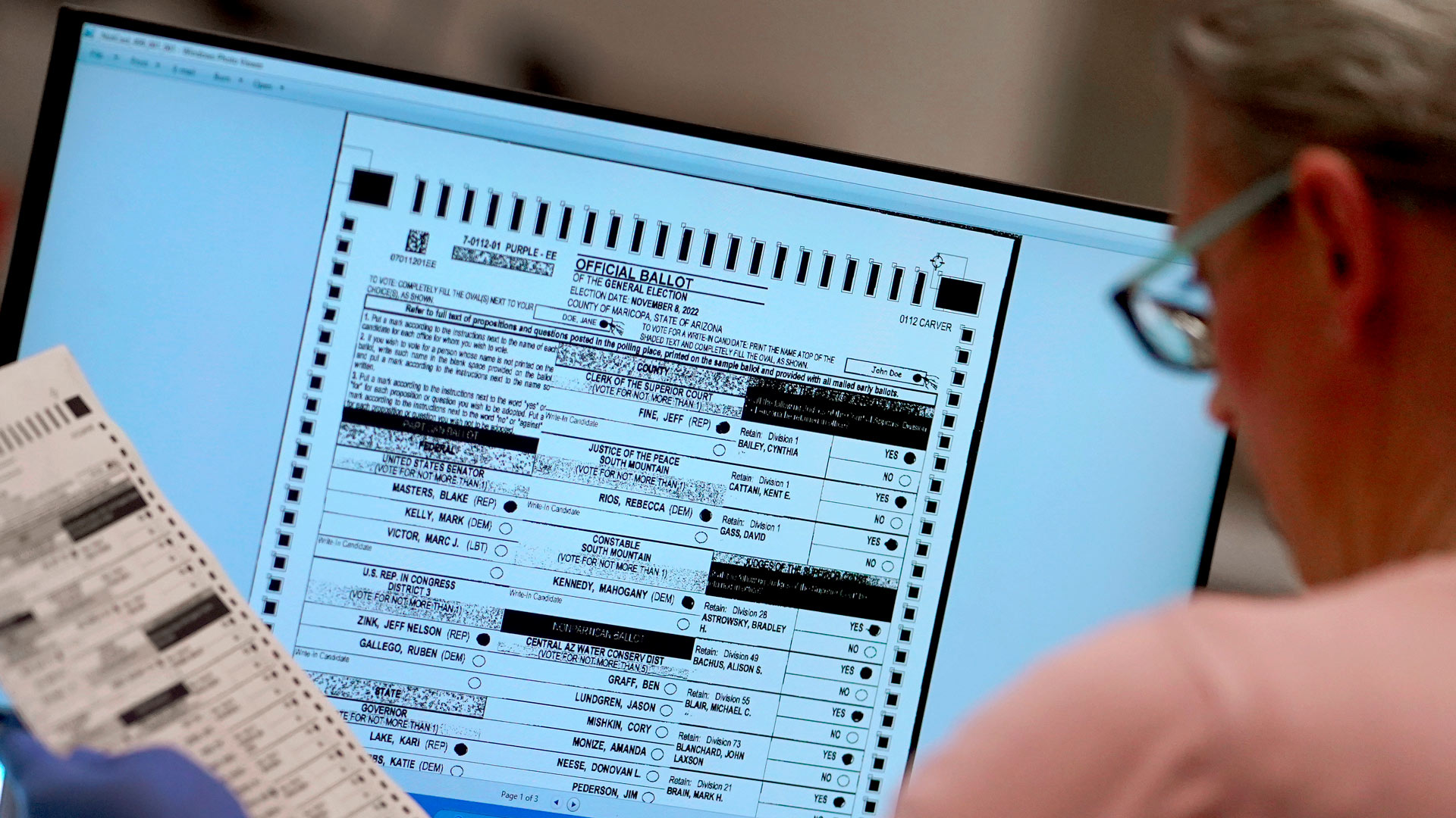 An election worker verifies a ballot on a screen inside the Maricopa County Recorders Office, Thursday, Nov. 10, 2022, in Phoenix. On Friday, Dec. 2, The Associated Press reported on stories circulating online incorrectly claiming Arizona’s Maricopa County announced that more than 540,000 voters visited voting centers on Election Day and that only 248,000 Election Day ballots were counted. Therefore, the county “lost” some 292,000 votes. 