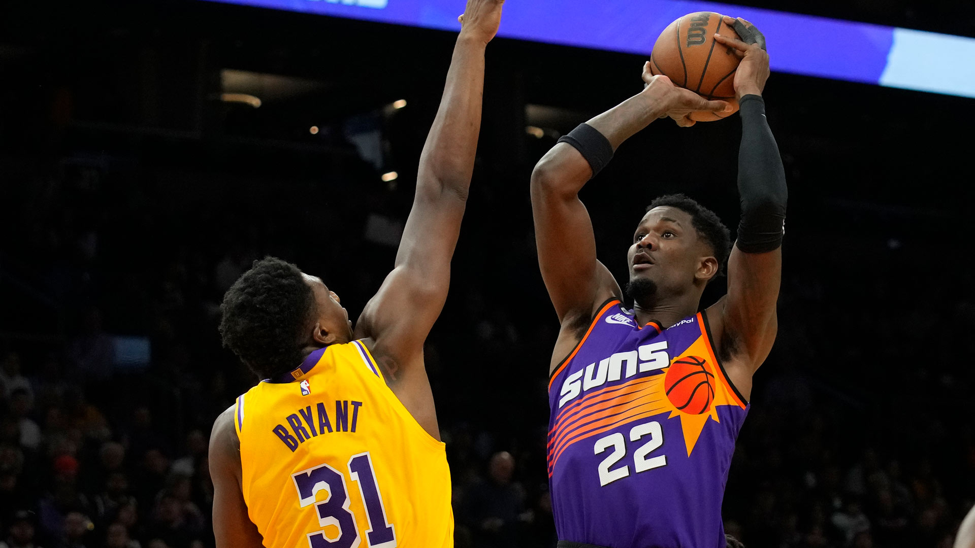 Phoenix Suns center Deandre Ayton shoots over Los Angeles Lakers center Thomas Bryant (31) during the second half of an NBA basketball game, Monday, Dec. 19, 2022, in Phoenix. 