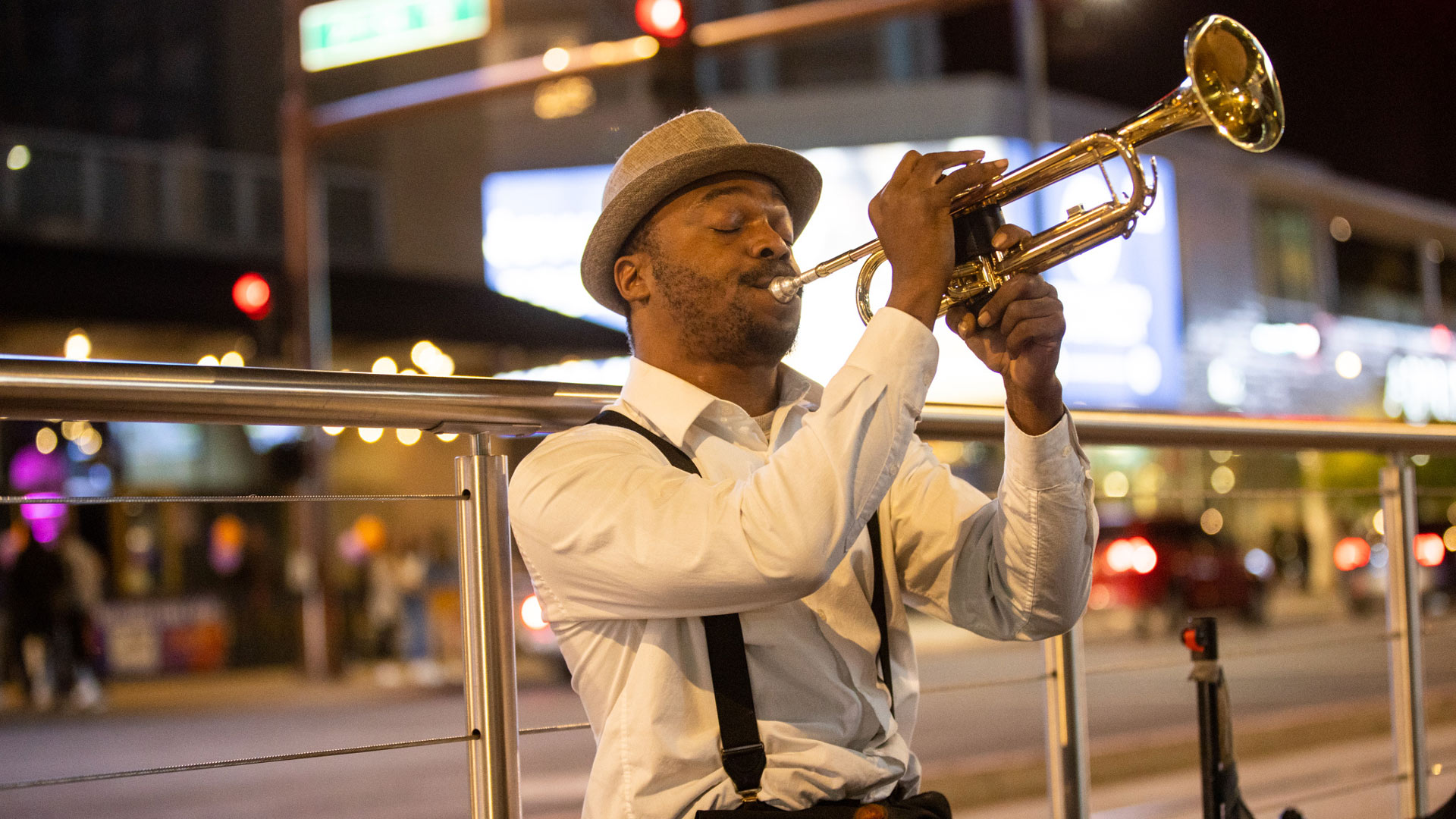 Trumpet player Edward Conway performs outside Footprint Center.