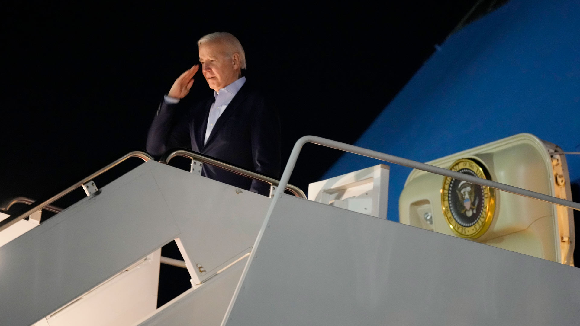 President Joe Biden salutes as he boards Air Force One at Andrews Air Force Base, Md., on Tuesday, Dec. 27, 2022.
