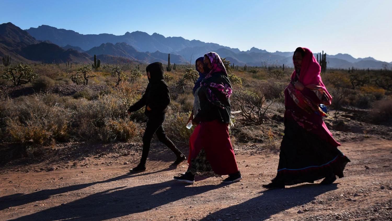 A group walks through the desert from Punta Chueca toward Saaps, where the Comcaac Nation held a historic gathering to demand water on March 27, 2021.