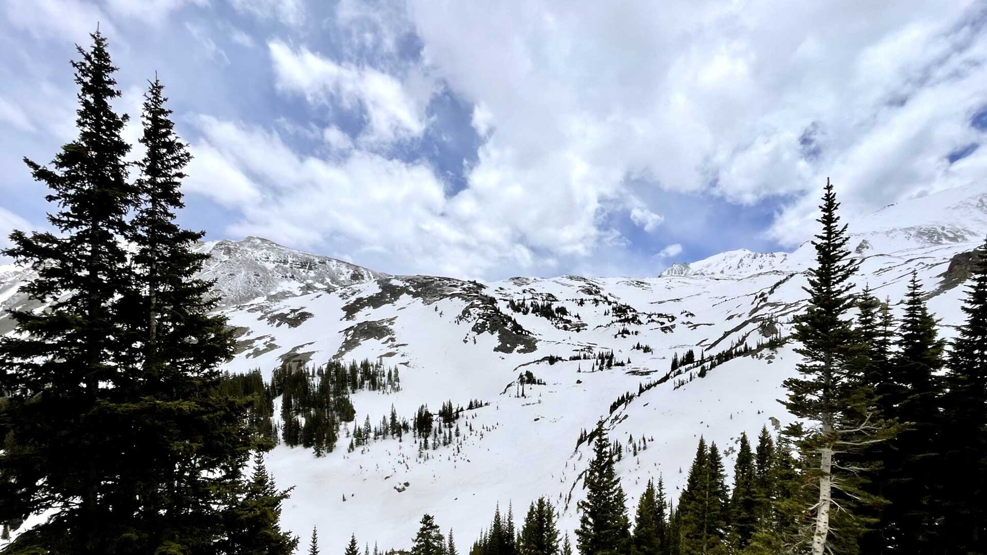 Snow hangs in Colorado's Elk Mountains in May 2022. The Colorado River gets the majority of its water from high-altitude snowpack, and climate scientists say it's likely that less water than normal will make it into rivers and streams.