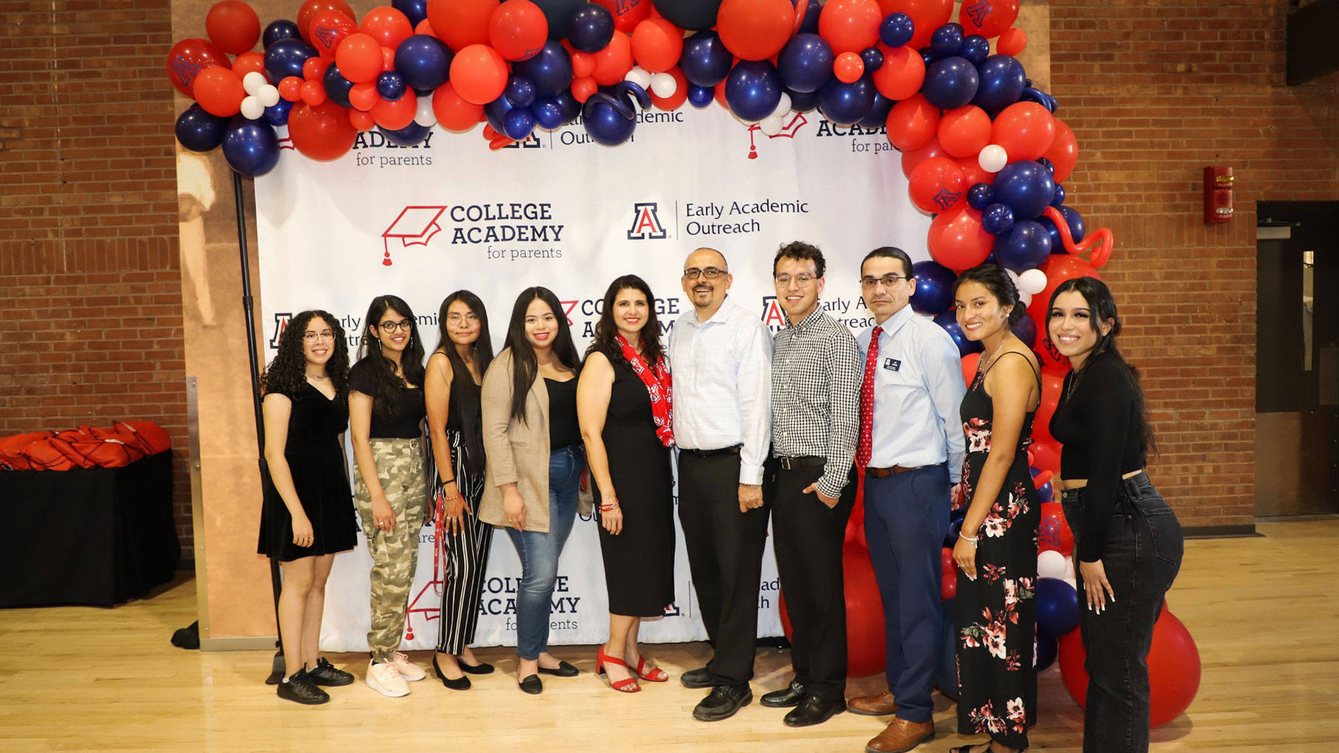 Program director Rudy McCormack (center) and staff at UA College Academy for Parents.