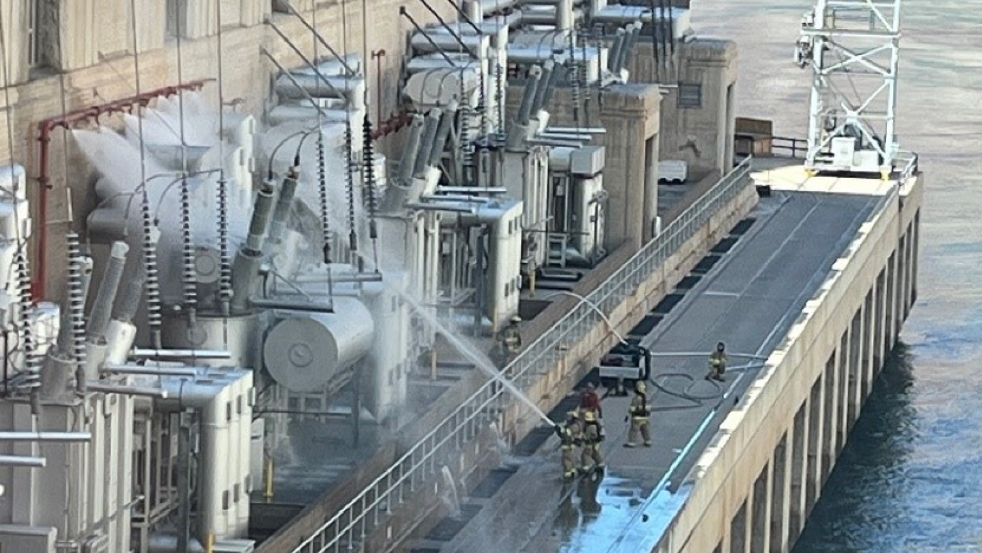 Firefighters spray water on a transformer that caught fire at Hoover Dam, July 19, 2022.