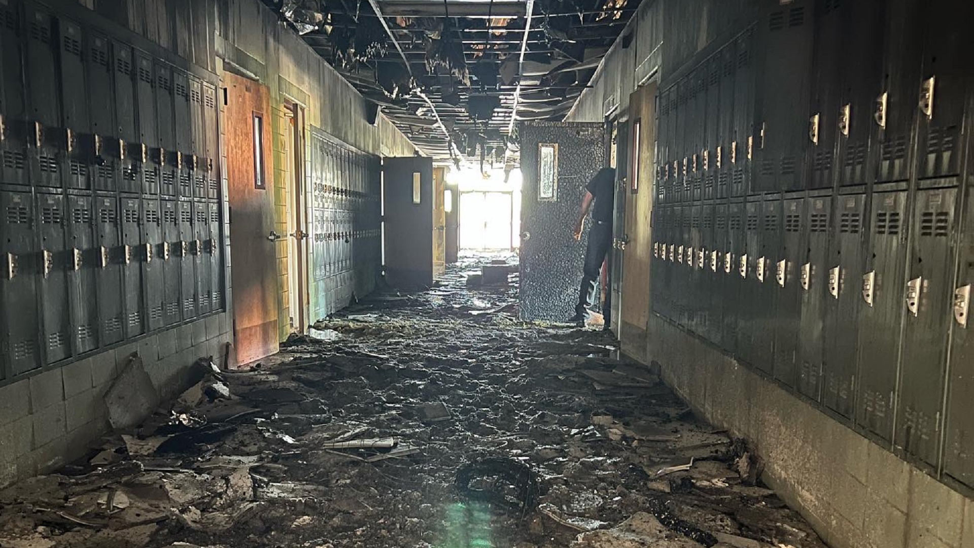 A Tucson firefighter checks out damage in the English wing of Salpointe High school in Tucson, Monday July 18, 2022.