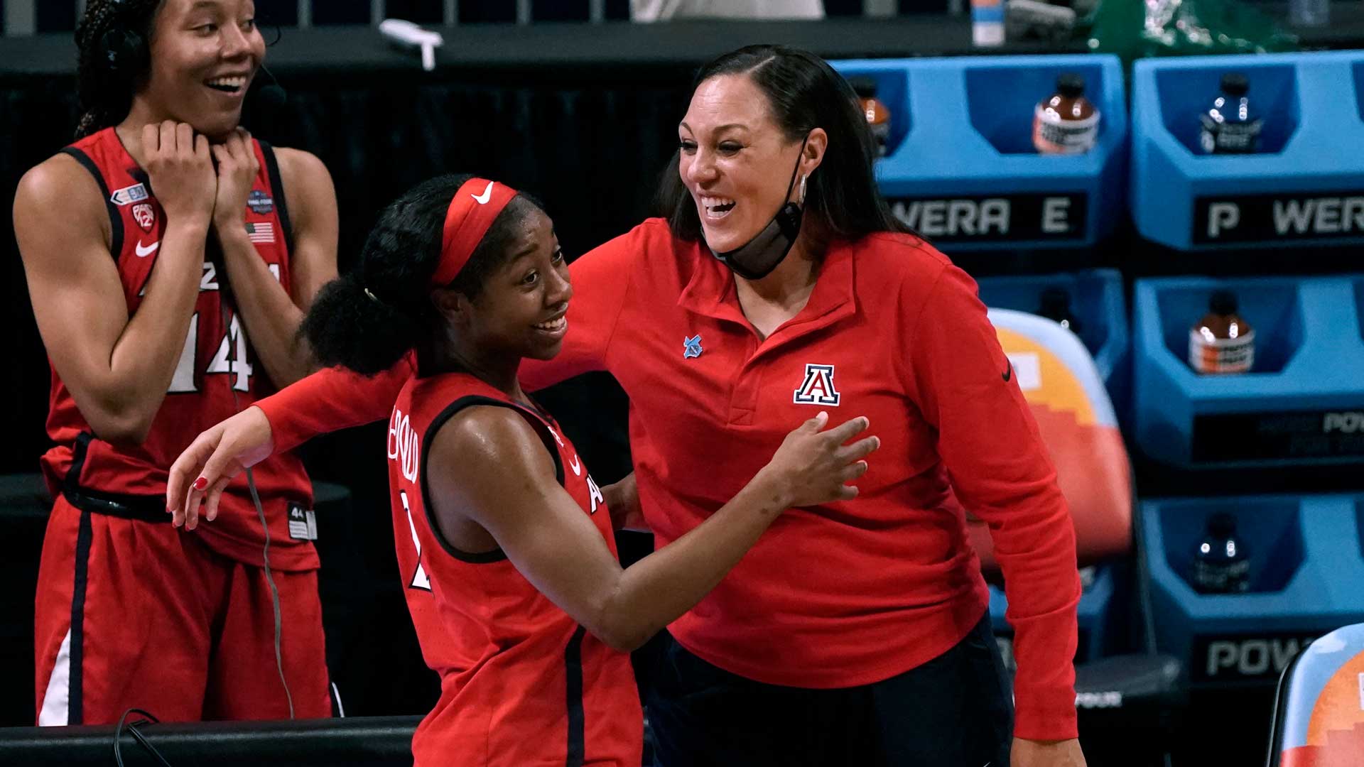 Arizona guard Aari McDonald, left, celebrates with head coach Adia Barnes at the end of a women's Final Four NCAA college basketball tournament semifinal game against Connecticut Friday, April 2, 2021, at the Alamodome in San Antonio. Arizona won 69-59.