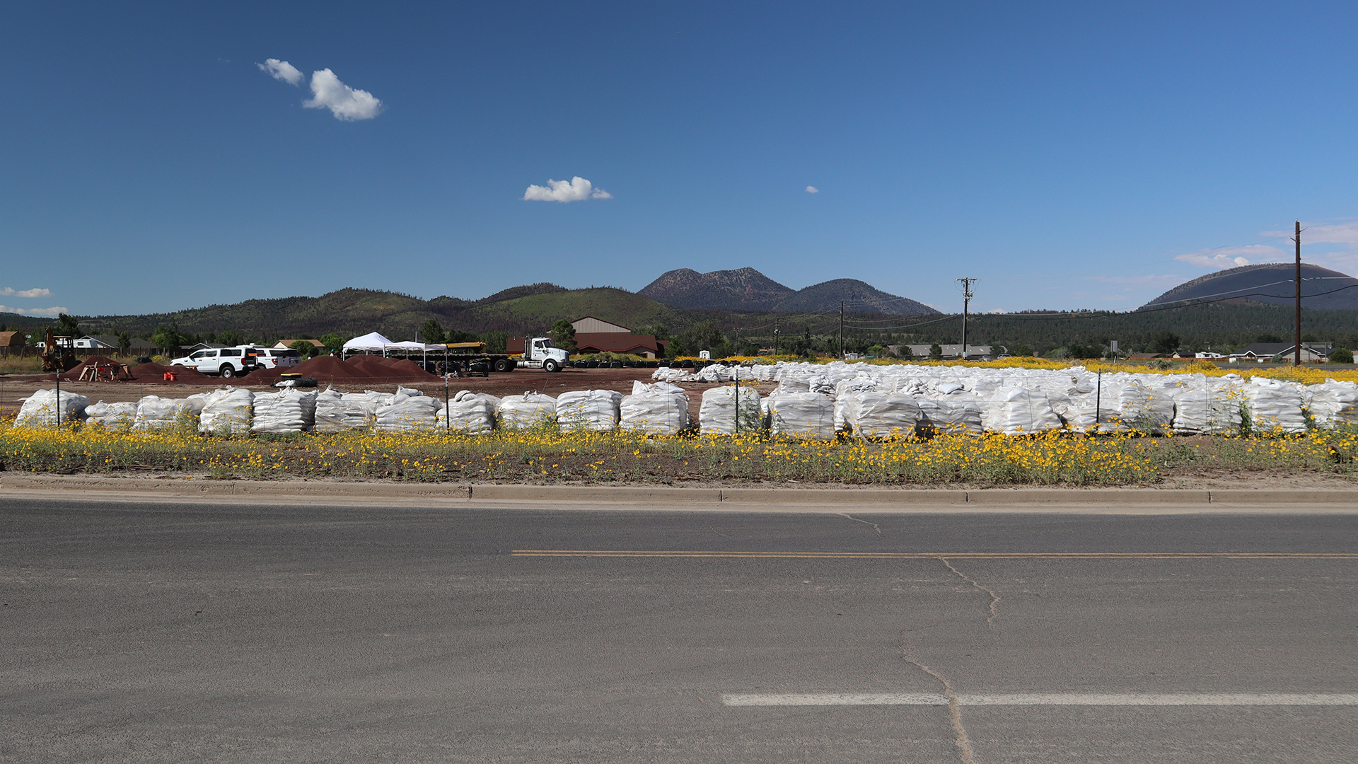 A vacant lot is used as a place to stack and assemble sandbags for use by residents whose properties are at risk of flooding.