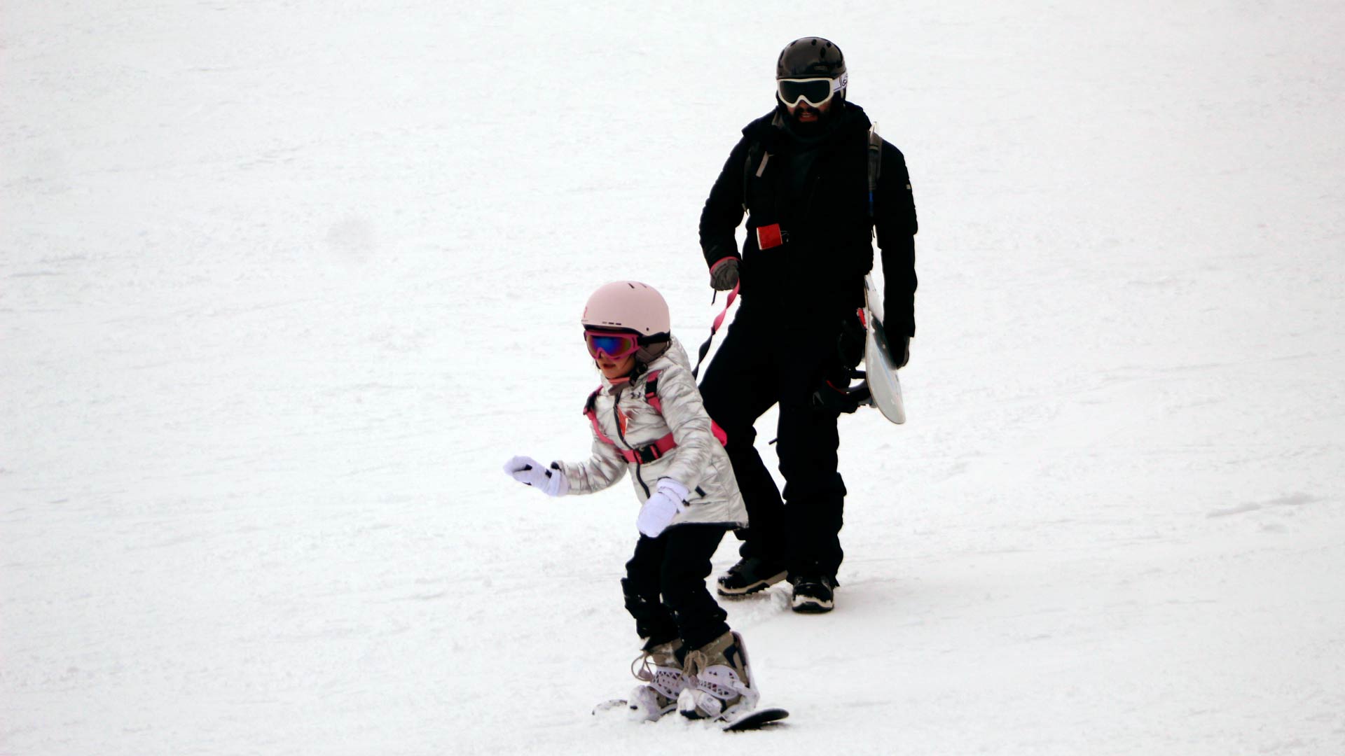 girl learns to snowboard