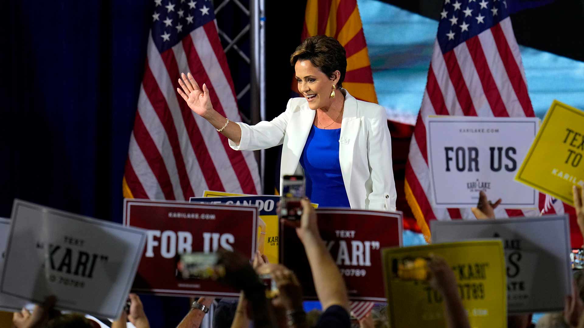 Republican candidate Kari Lake waves to supporters as she arrives on stage to announce her plans to run for the Arizona U.S. Senate seat during a rally, on Tuesday, Oct. 10, 2023, in Scottsdale, Ariz. 
