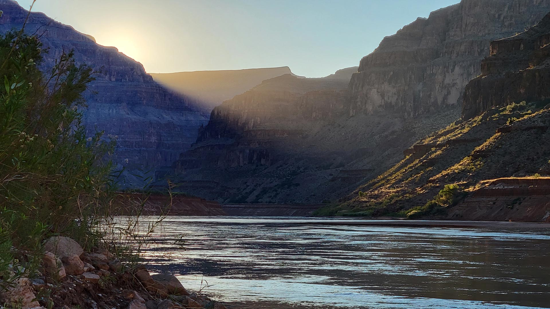 The sun rises over the Colorado River in the Grand Canyon.