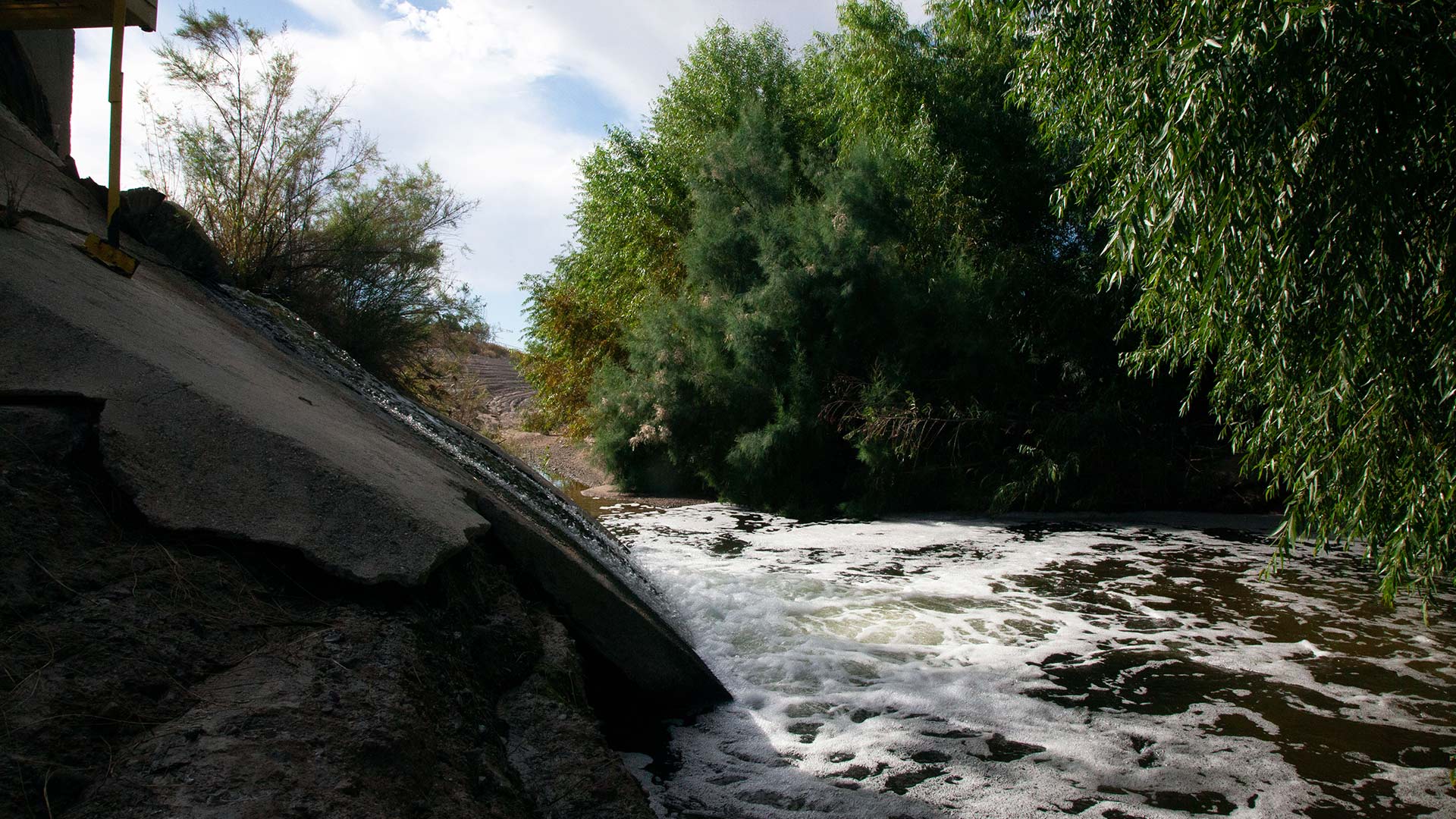 Effluent gushes out of the outfall, into the Santa Cruz River. The outfall of water is constantly flowing, but there is a diurnal fluctuation due to cyclical human water use. 