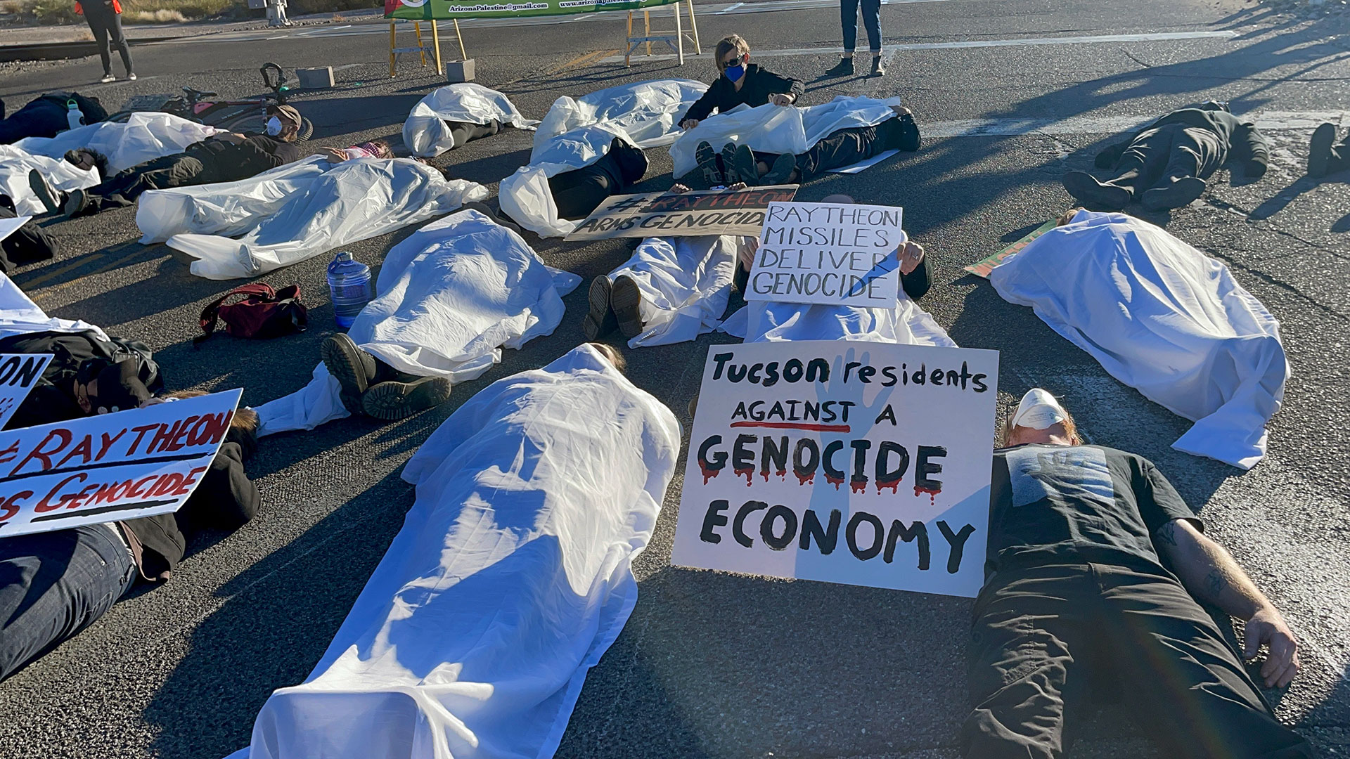 Demonstrators lie on the asphalt to “bring death to Raytheon’s doorstep” in a protest of the company’s (now RTX) weapons sales to Israel. 
