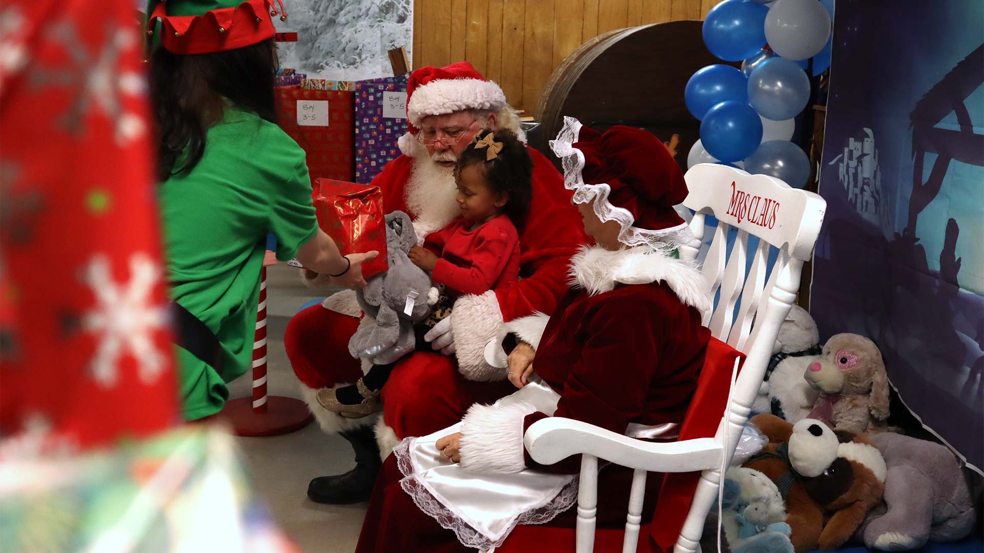 Journey Bush, age 2 and an half, sits on Santa's lap and tells him and Mrs. Claus what she wants for Christmas during the 11th annual Santa on the West End event in Sierra Vista. November 26, 2023. 