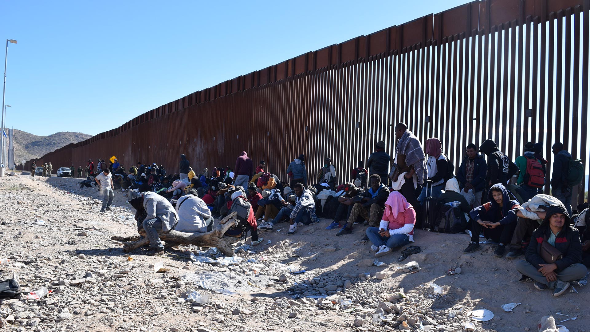 Migrants wait to be processed by border patrol outside of Lukeville, Arizona, on Dec. 5, 2023.