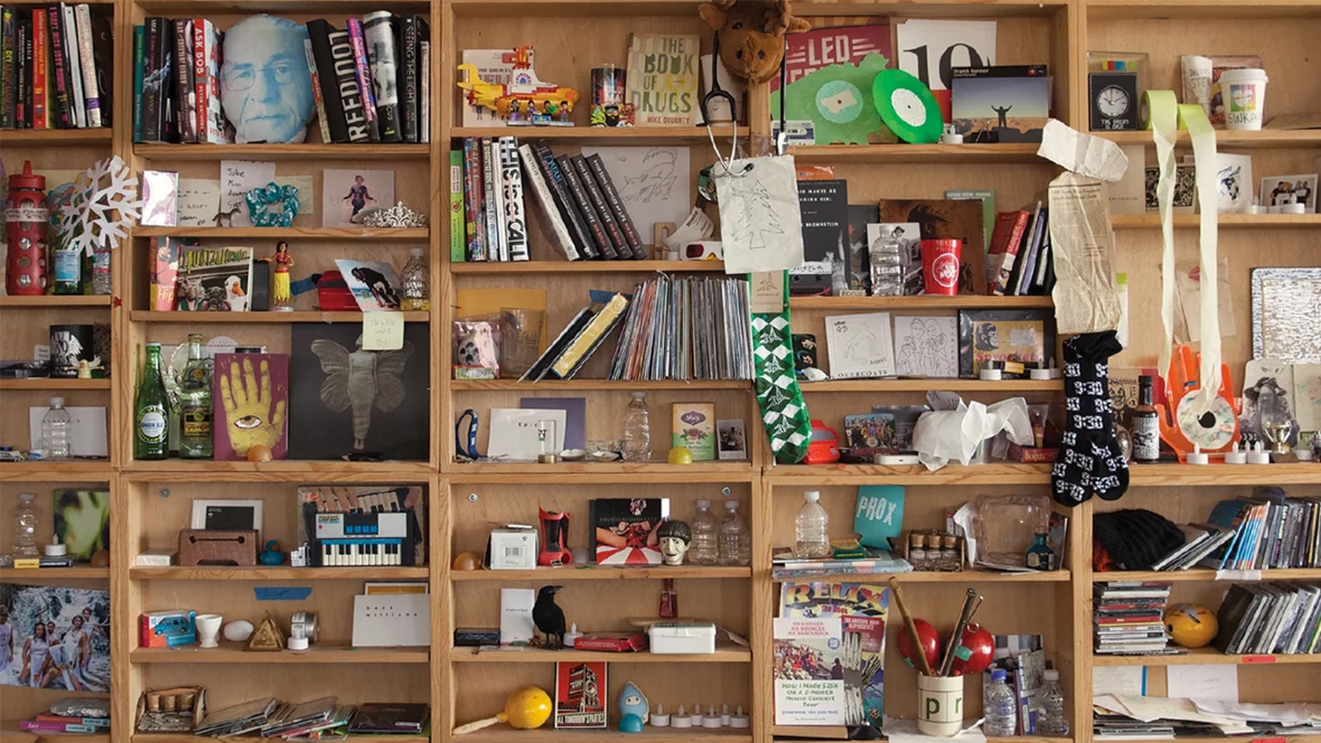 The bric-a-brac-stacked shelves of the Tiny Desk.