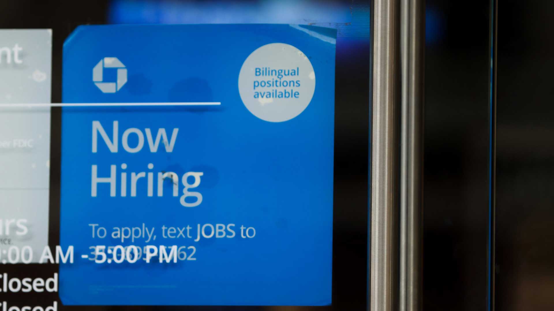 A now-hiring sign is posted at Chase Bank in downtown Phoenix. February 2023