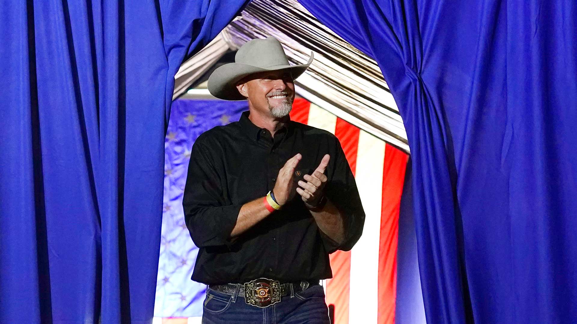 Pinal County sheriff Mark Lamb applauds as he walks on stage at a Save America Rally Friday, July 22, 2022, in Prescott, Ariz.