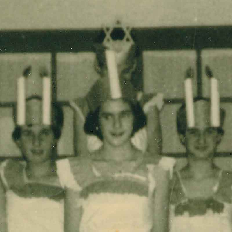 As a young teen, Paula met other Jewish youth in Eindhoven. In this photo, they are celebrating Hanukah by dressing as a menorah. Paula, the tallest, is in the middle.