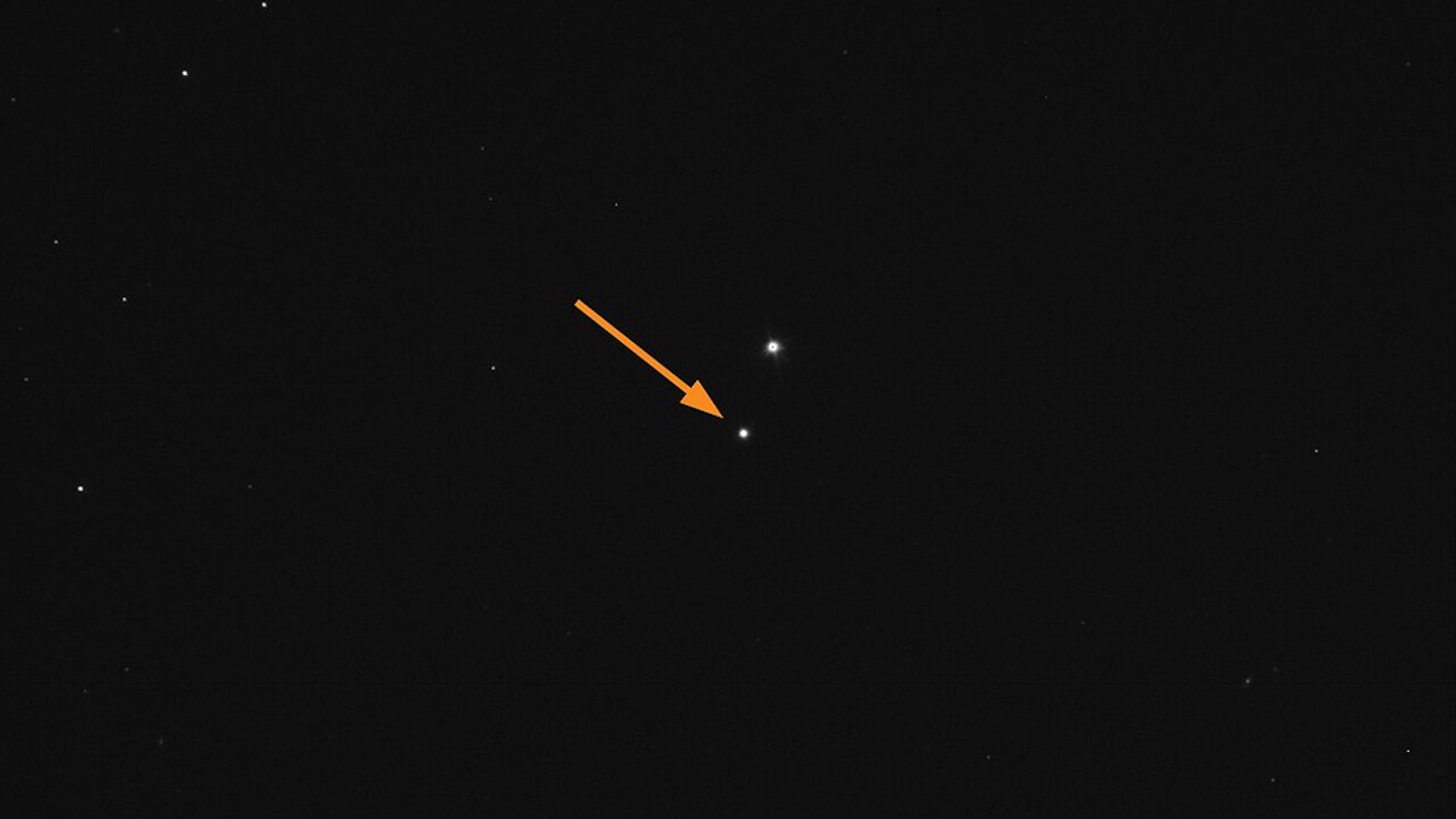 Image showing asteroid Didymos (arrow) against background of stars.